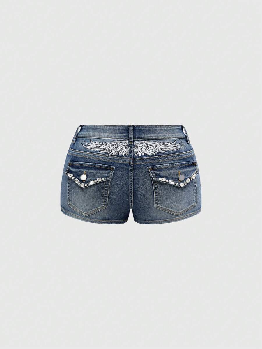 Blue ultra low waist mini shorts with ripped details, zipper fly, button closure, back wing embroidery, and rhinestone decor in a Y2K grunge punk style.