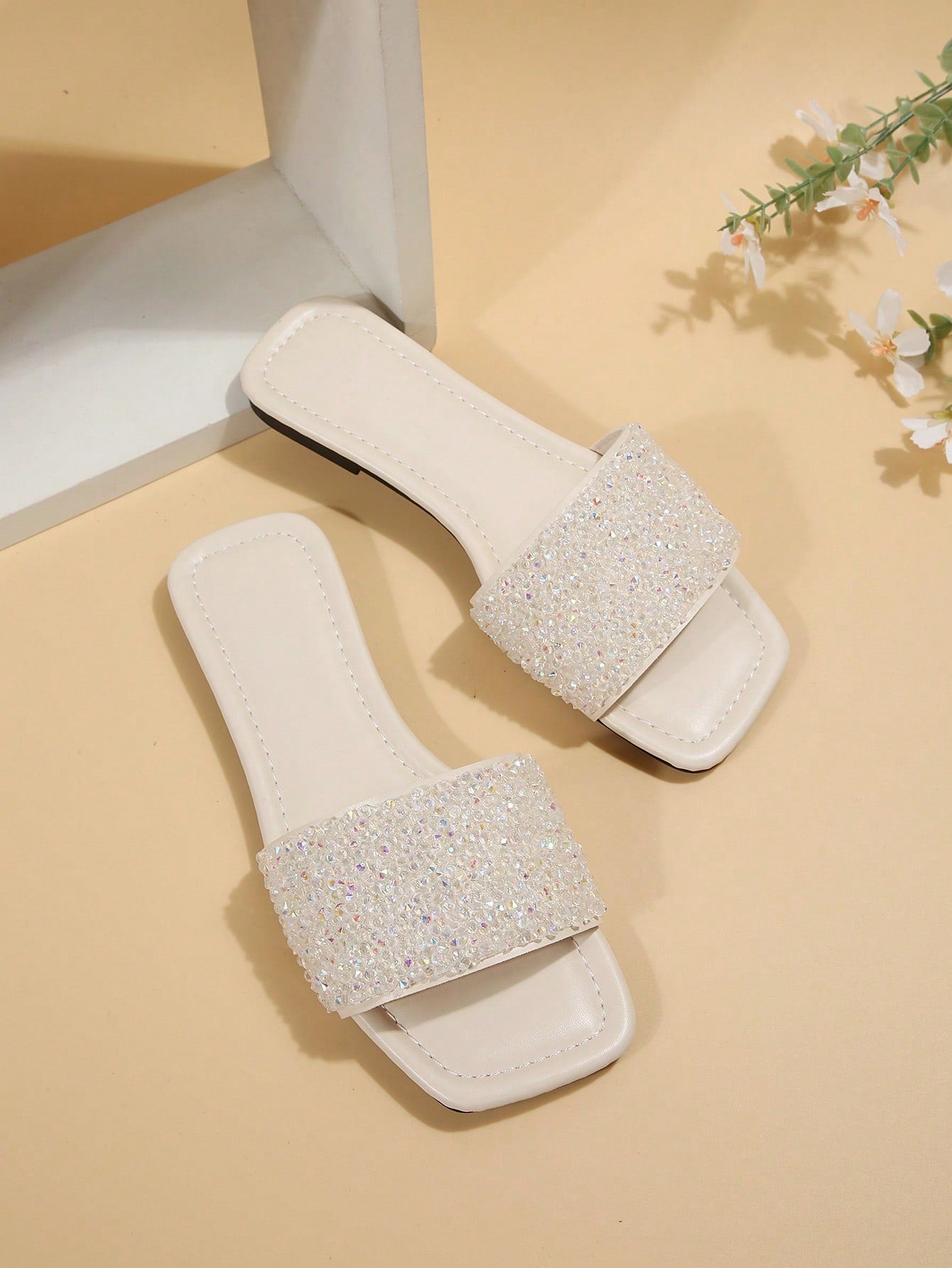 Black plus size women's slip-on flat slide sandals with square open toe, soft non-slip sole, and pearl rhinestone embellishments.