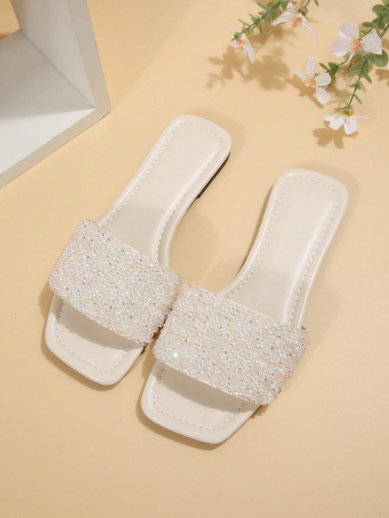 Black plus size women's slip-on flat slide sandals with square open toe, soft non-slip sole, and pearl rhinestone embellishments.