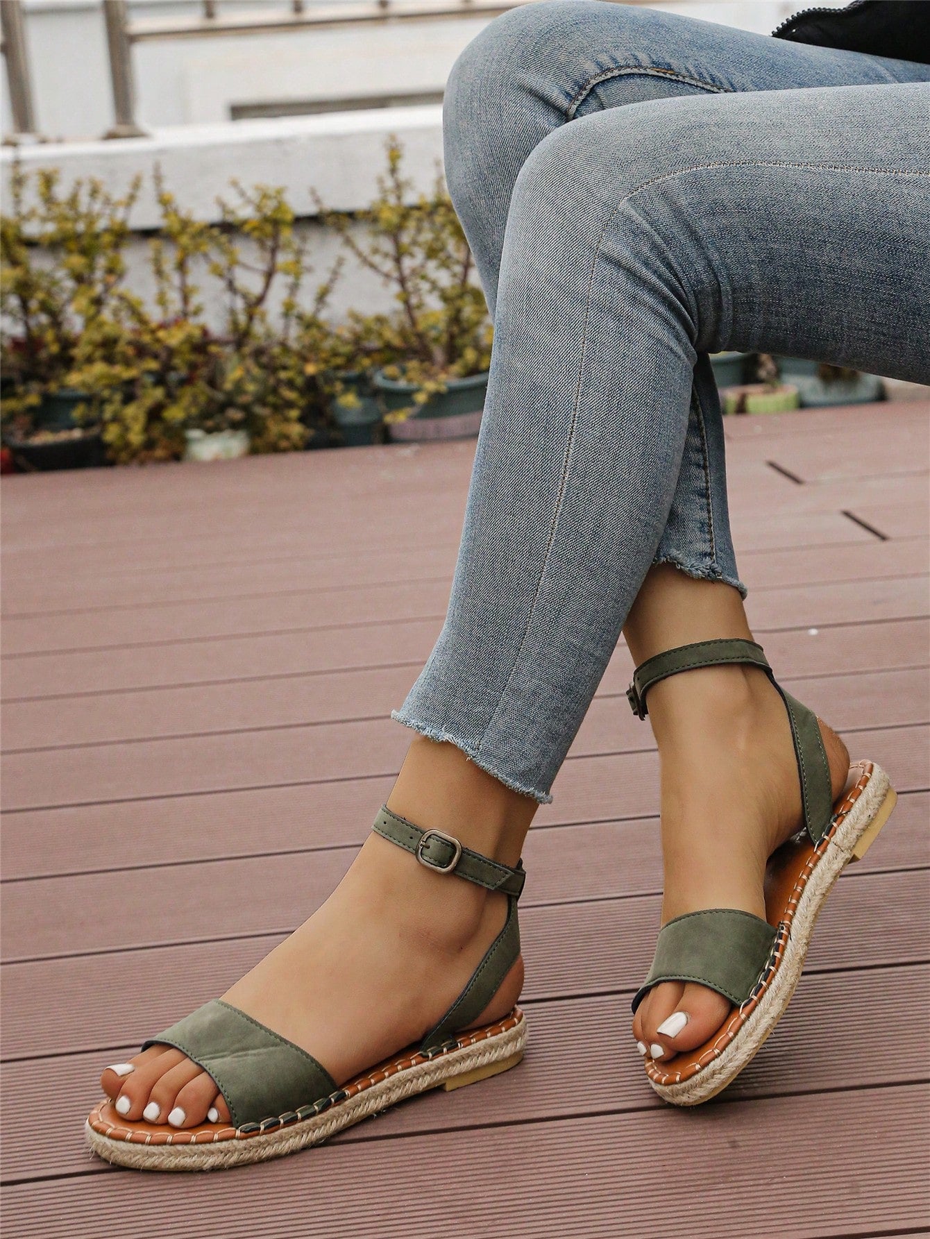 Women's woven Roman slide sandals with buckle detail, flat sole, and open-toe design for casual outdoor wear.