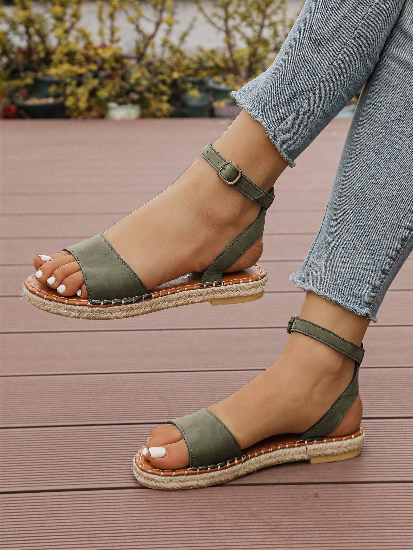 Women's woven Roman slide sandals with buckle detail, flat sole, and open-toe design for casual outdoor wear.