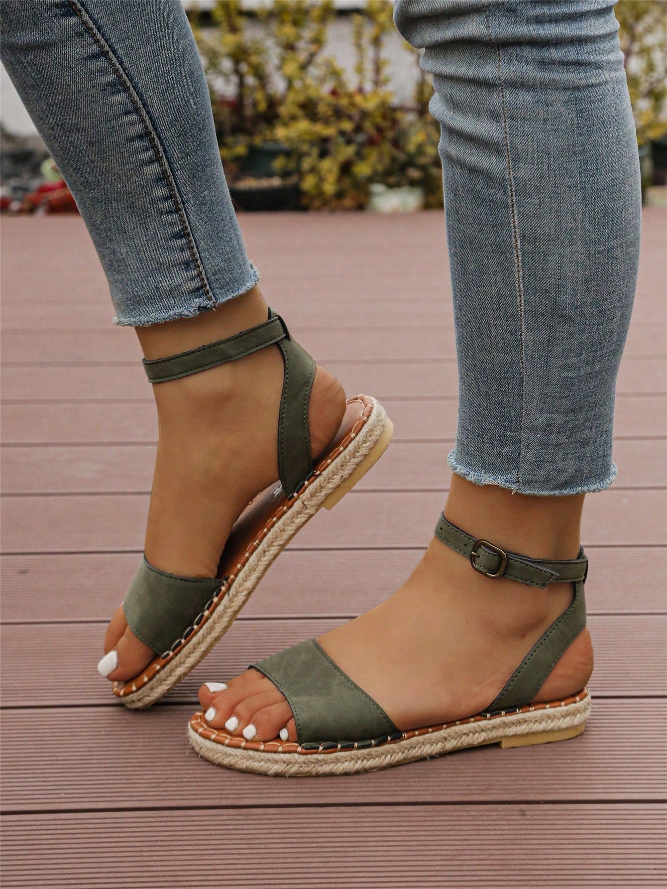 Women's woven Roman slide sandals with buckle detail, flat sole, and open-toe design for casual outdoor wear.