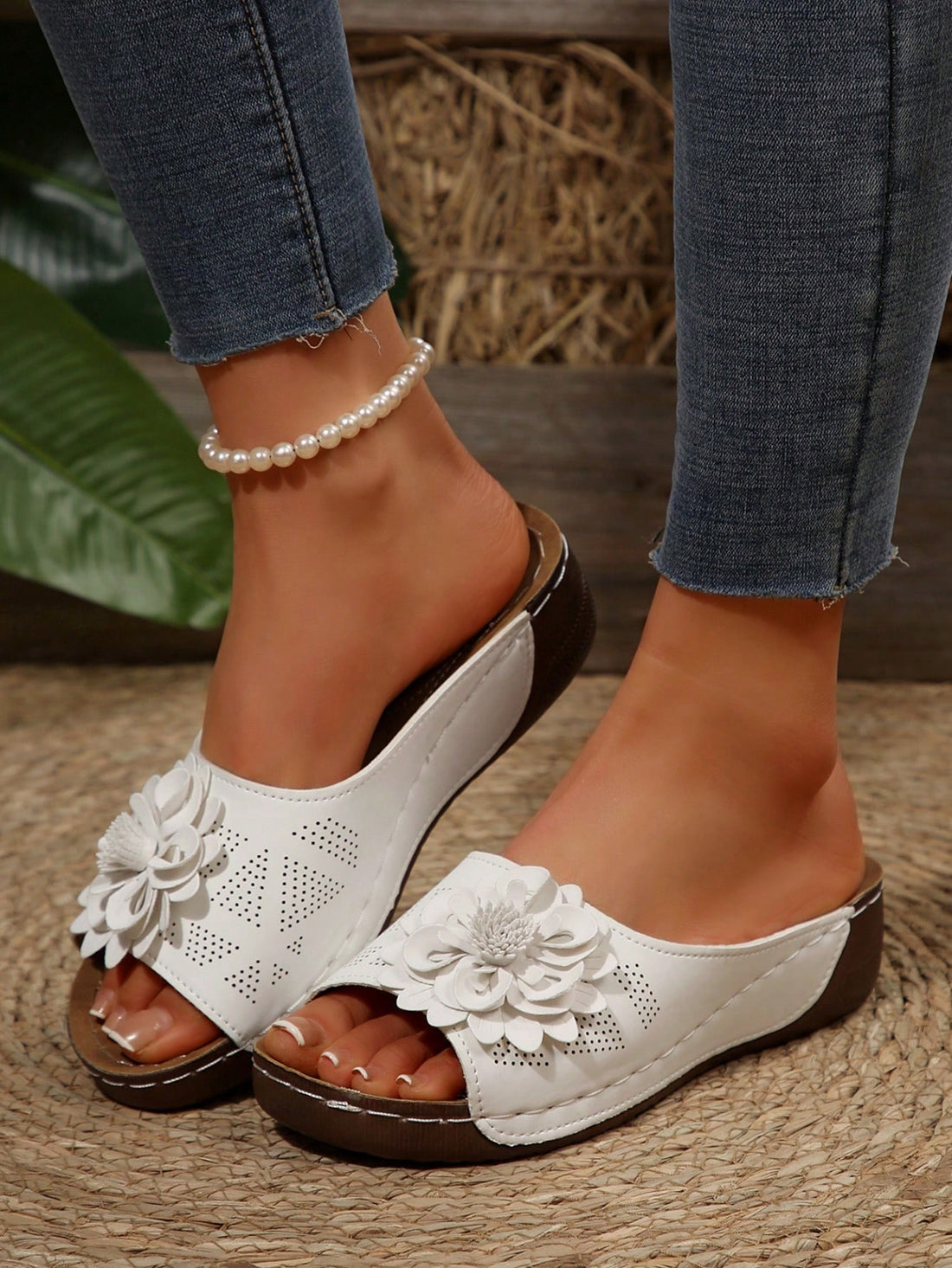 Women's white platform wedge slip-on sandals with open toe, thick sole, floral embroidery decor, and hollow-out upper detail.