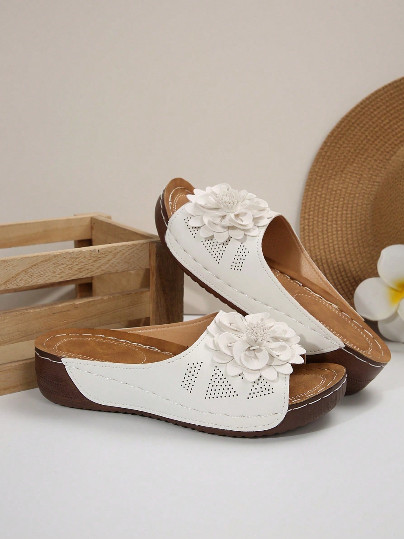 Women's white platform wedge slip-on sandals with open toe, thick sole, floral embroidery decor, and hollow-out upper detail.