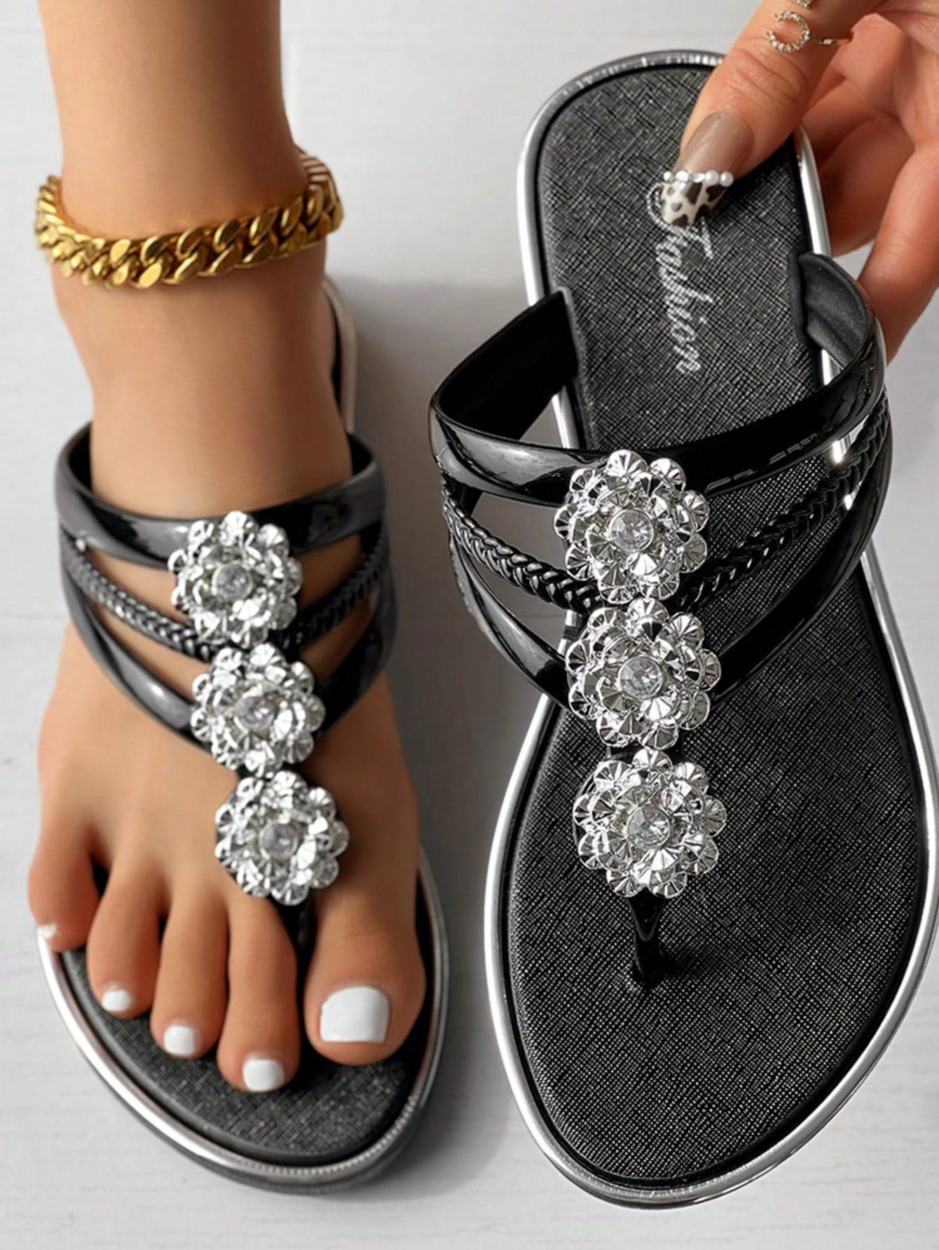 Women's gold metal-look open-toe strappy slide sandals with crystal floral rhinestone decor and flat sole, suitable for beach, vacation, and casual wear.