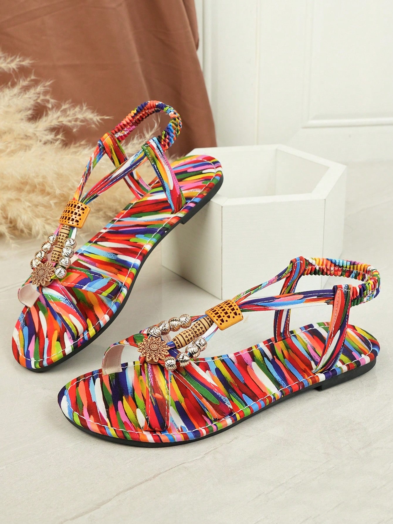 Women's beaded boho flat strappy sandals with open toe and tropical-inspired plain pattern, designed for beach and casual summer wear.