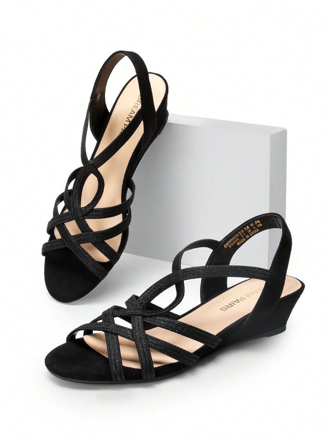 Women's open-toe low wedge sandals featuring crisscross straps, slingback ankle strap, and a classic wedge heel for dressy and everyday summer outfits.