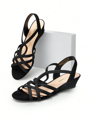 Women's open-toe low wedge sandals featuring crisscross straps, slingback ankle strap, and a classic wedge heel for dressy and everyday summer outfits.