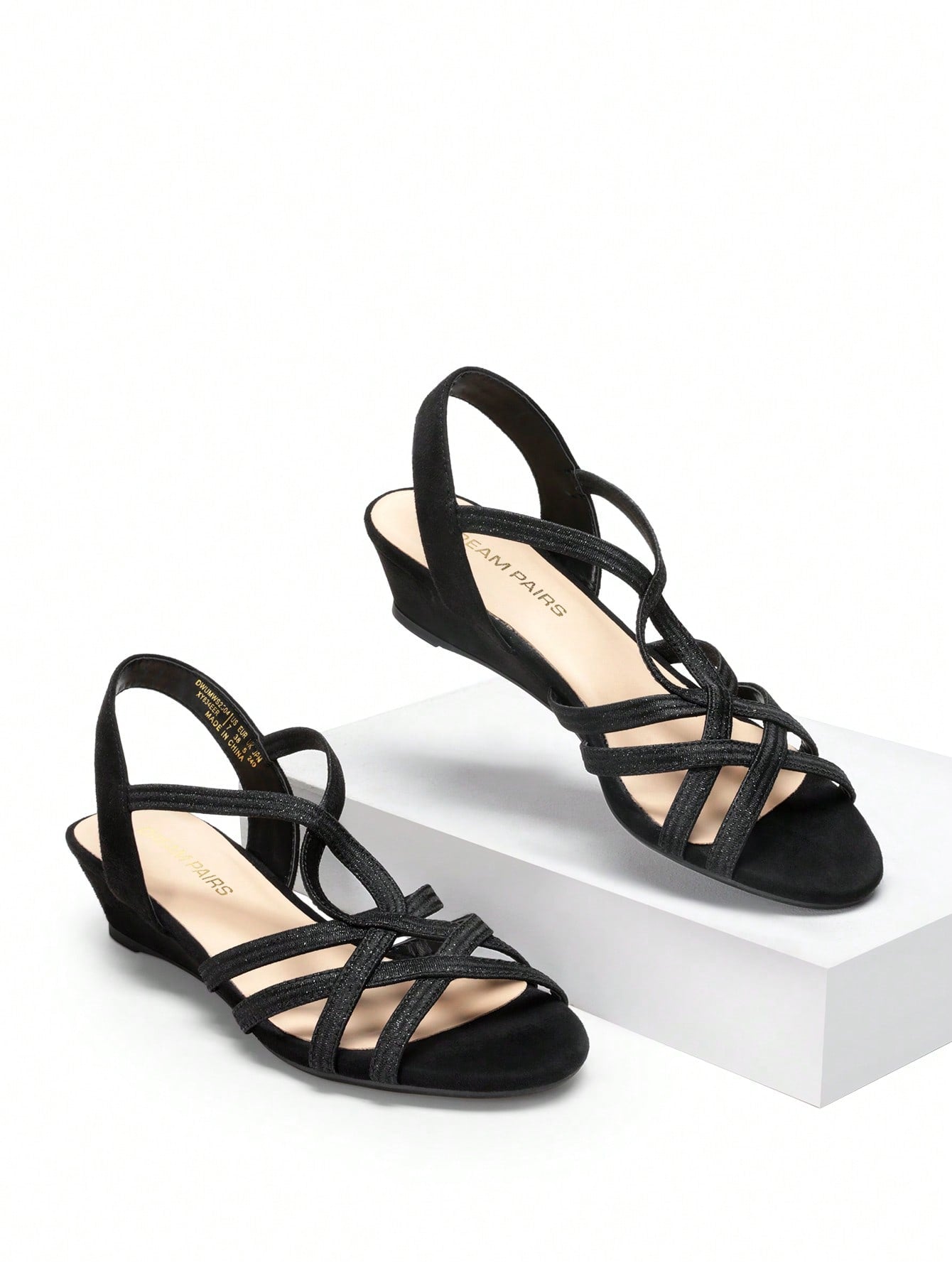 Women's open-toe low wedge sandals featuring crisscross straps, slingback ankle strap, and a classic wedge heel for dressy and everyday summer outfits.