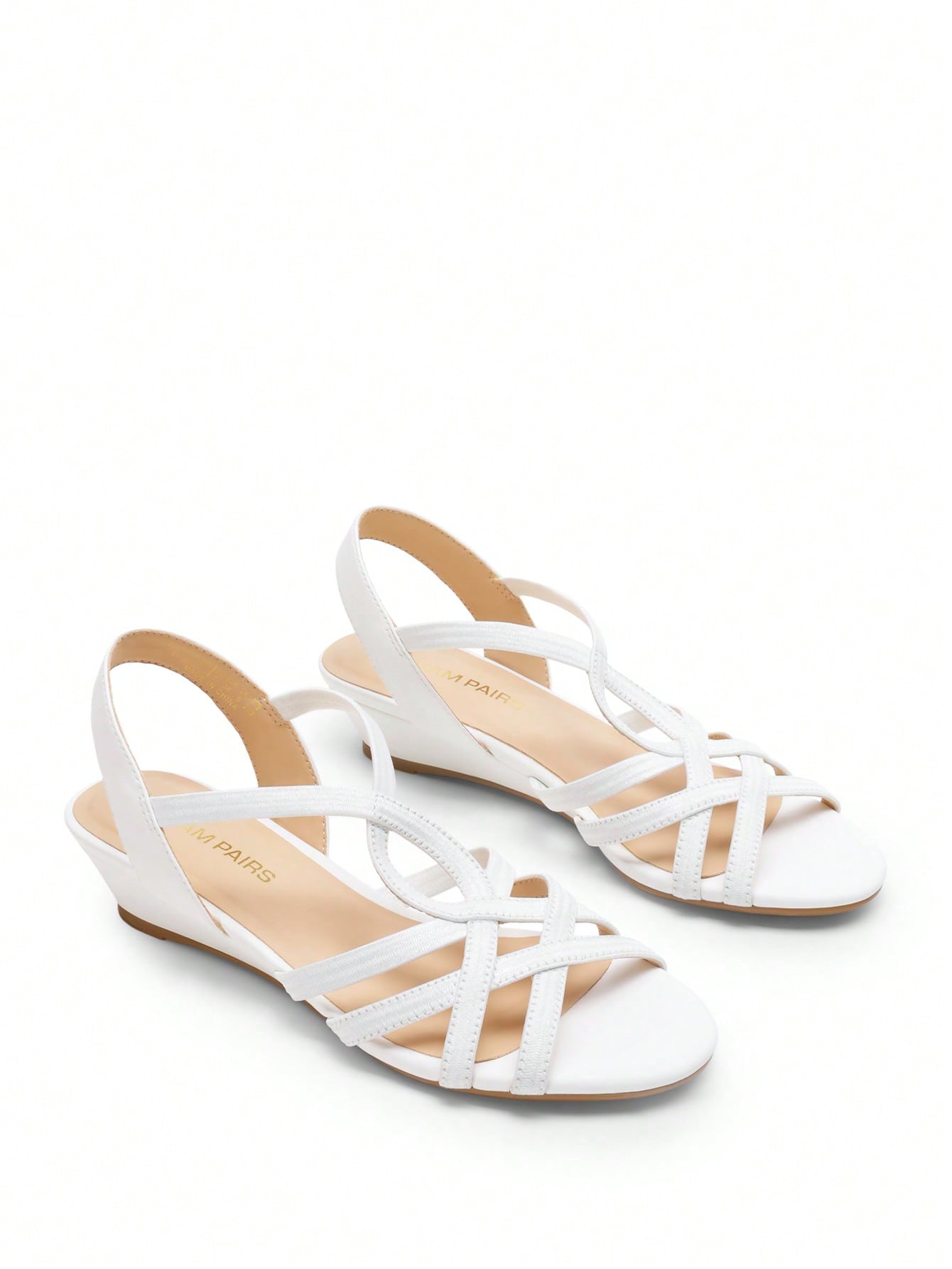 Women's open-toe low wedge sandals featuring crisscross straps, slingback ankle strap, and a classic wedge heel for dressy and everyday summer outfits.