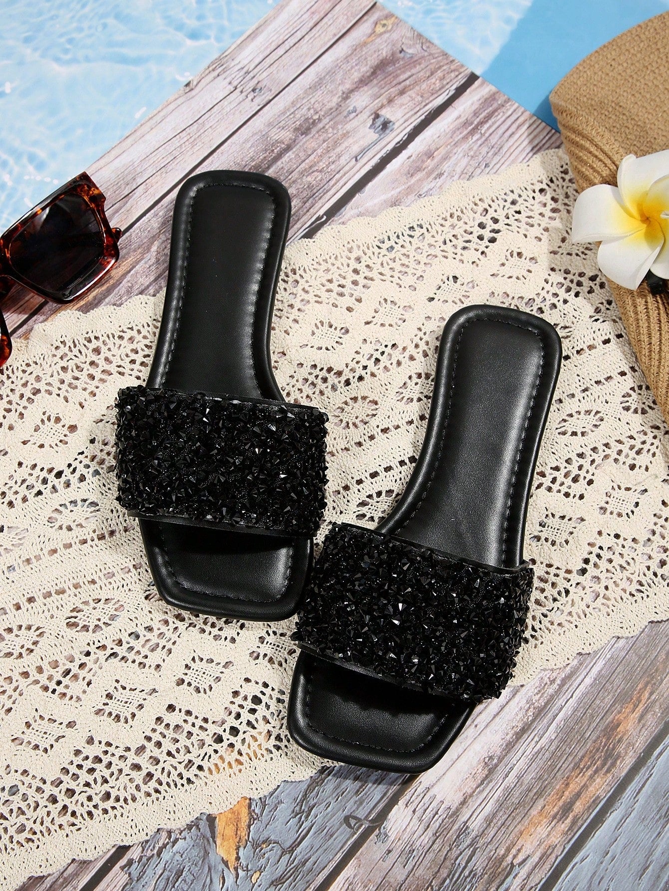 Black plus size women's slip-on flat slide sandals with square open toe, soft non-slip sole, and pearl rhinestone embellishments.