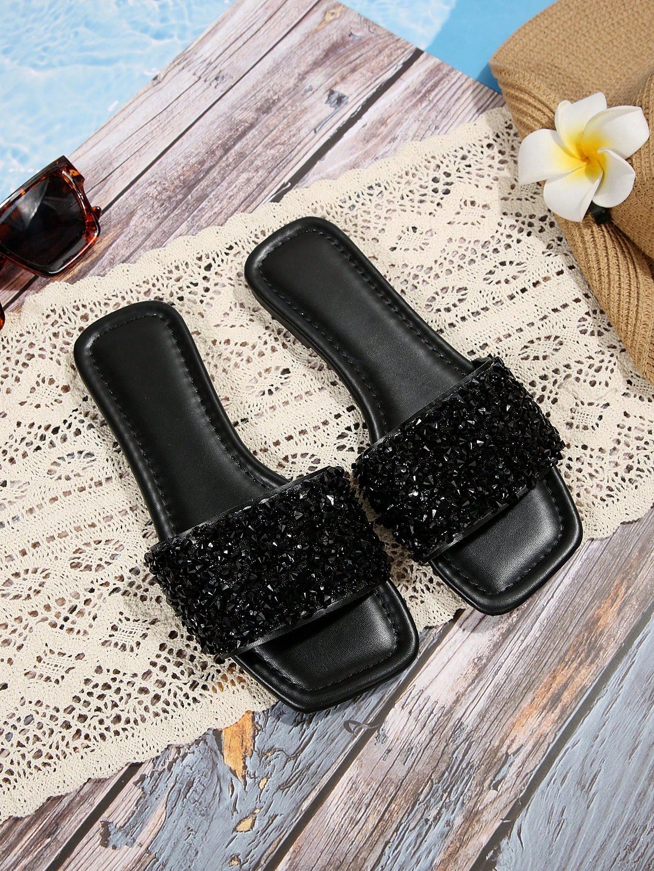 Black plus size women's slip-on flat slide sandals with square open toe, soft non-slip sole, and pearl rhinestone embellishments.