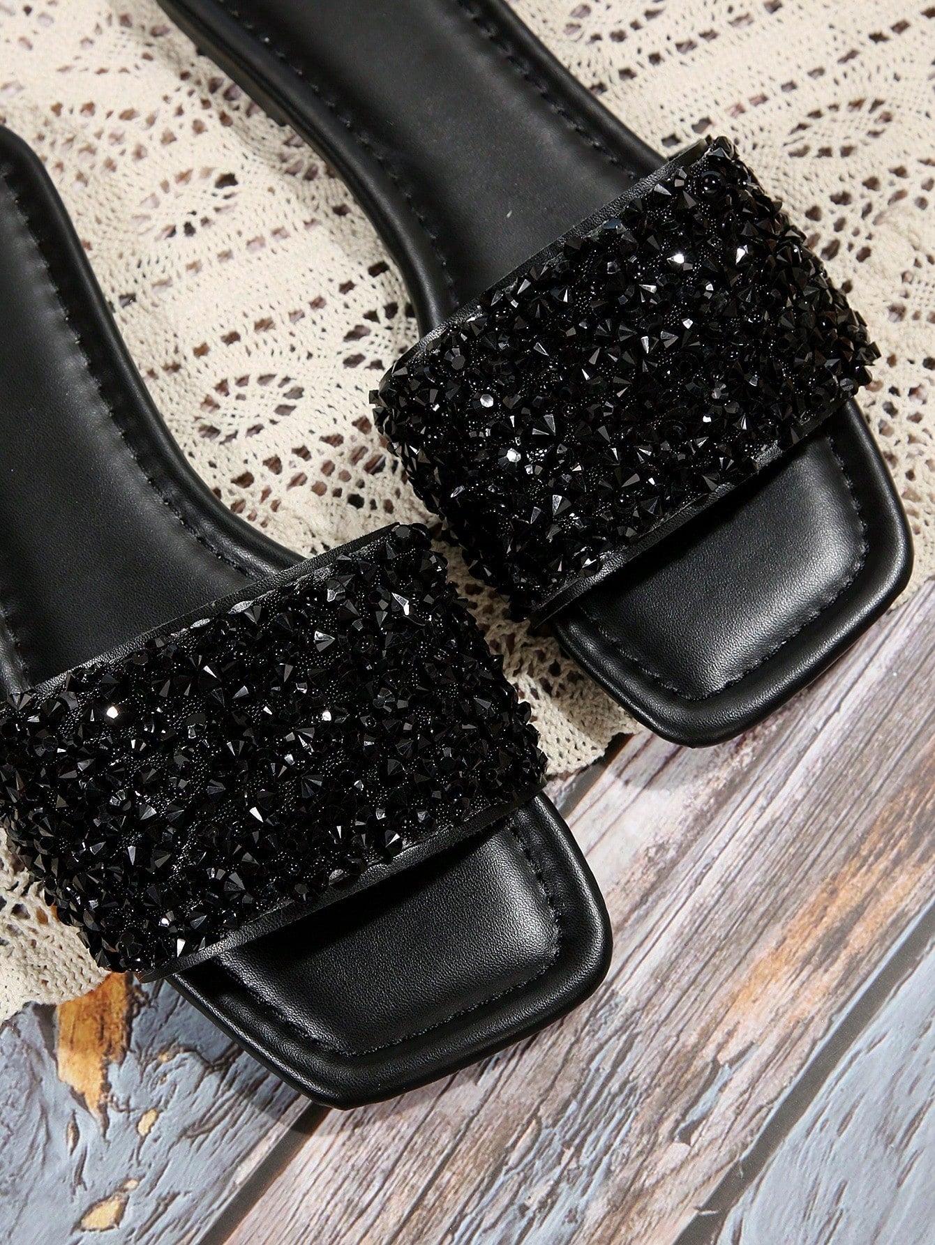 Black plus size women's slip-on flat slide sandals with square open toe, soft non-slip sole, and pearl rhinestone embellishments.