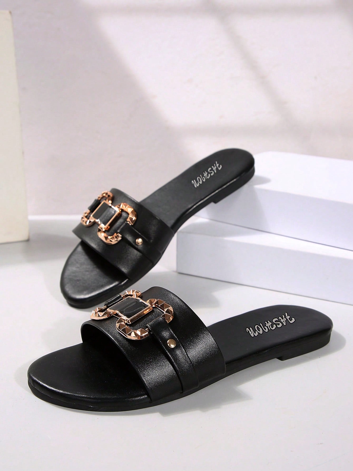 Women’s wide fit white flat slide mules with draped strap detail, square buckle accent, and open toe design, suitable for summer daily wear, vacation, and outdoor activities.