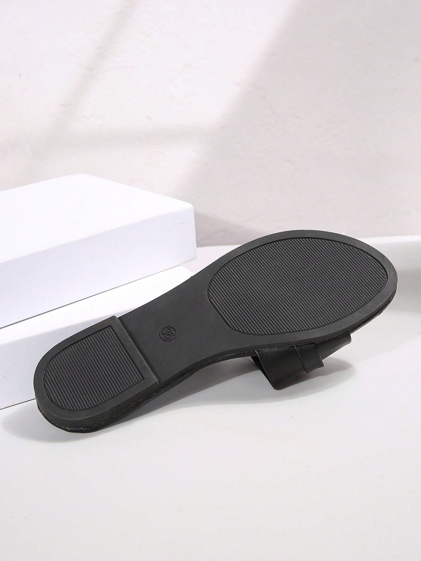 Women’s wide fit white flat slide mules with draped strap detail, square buckle accent, and open toe design, suitable for summer daily wear, vacation, and outdoor activities.