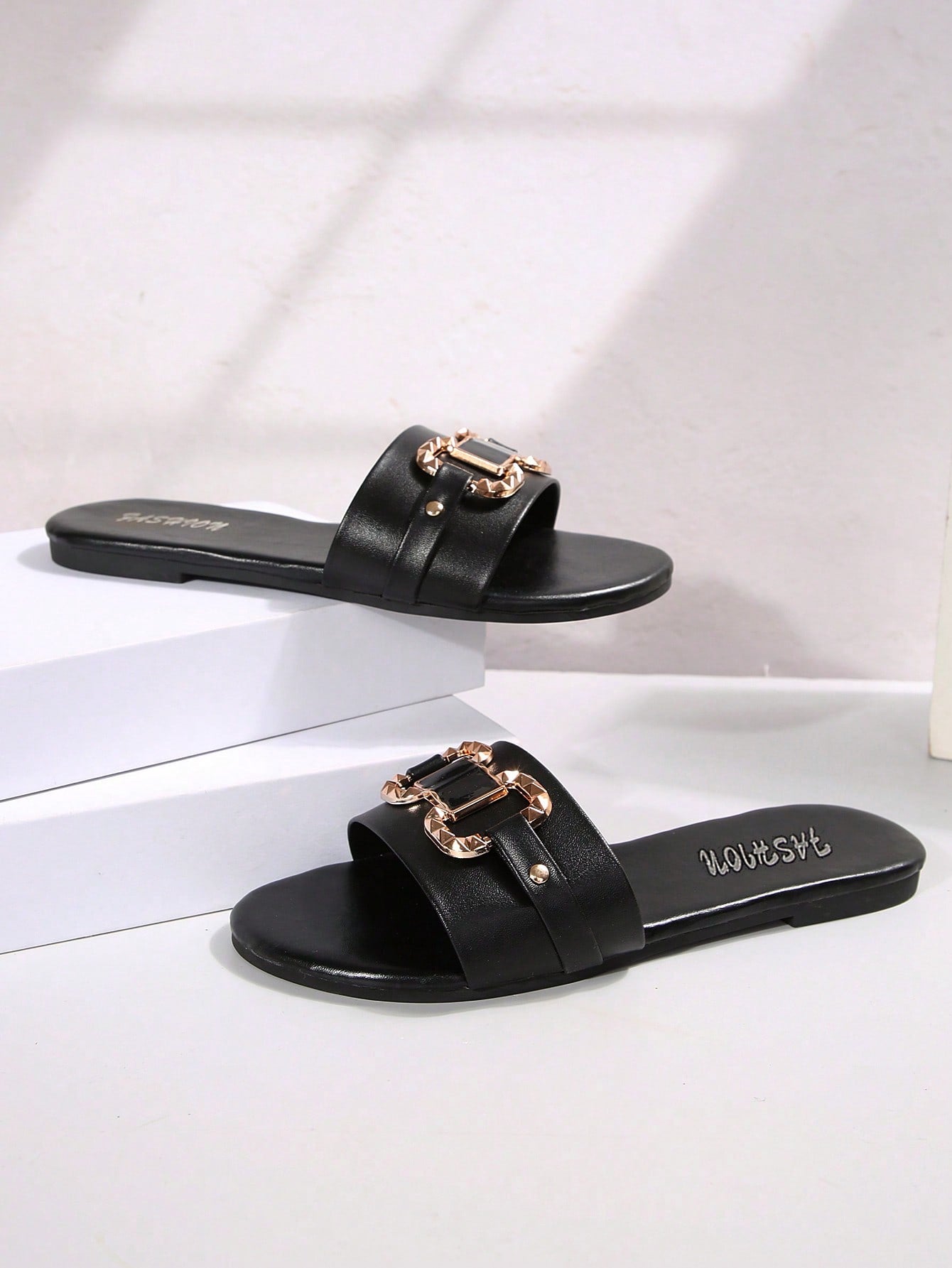 Women’s wide fit white flat slide mules with draped strap detail, square buckle accent, and open toe design, suitable for summer daily wear, vacation, and outdoor activities.