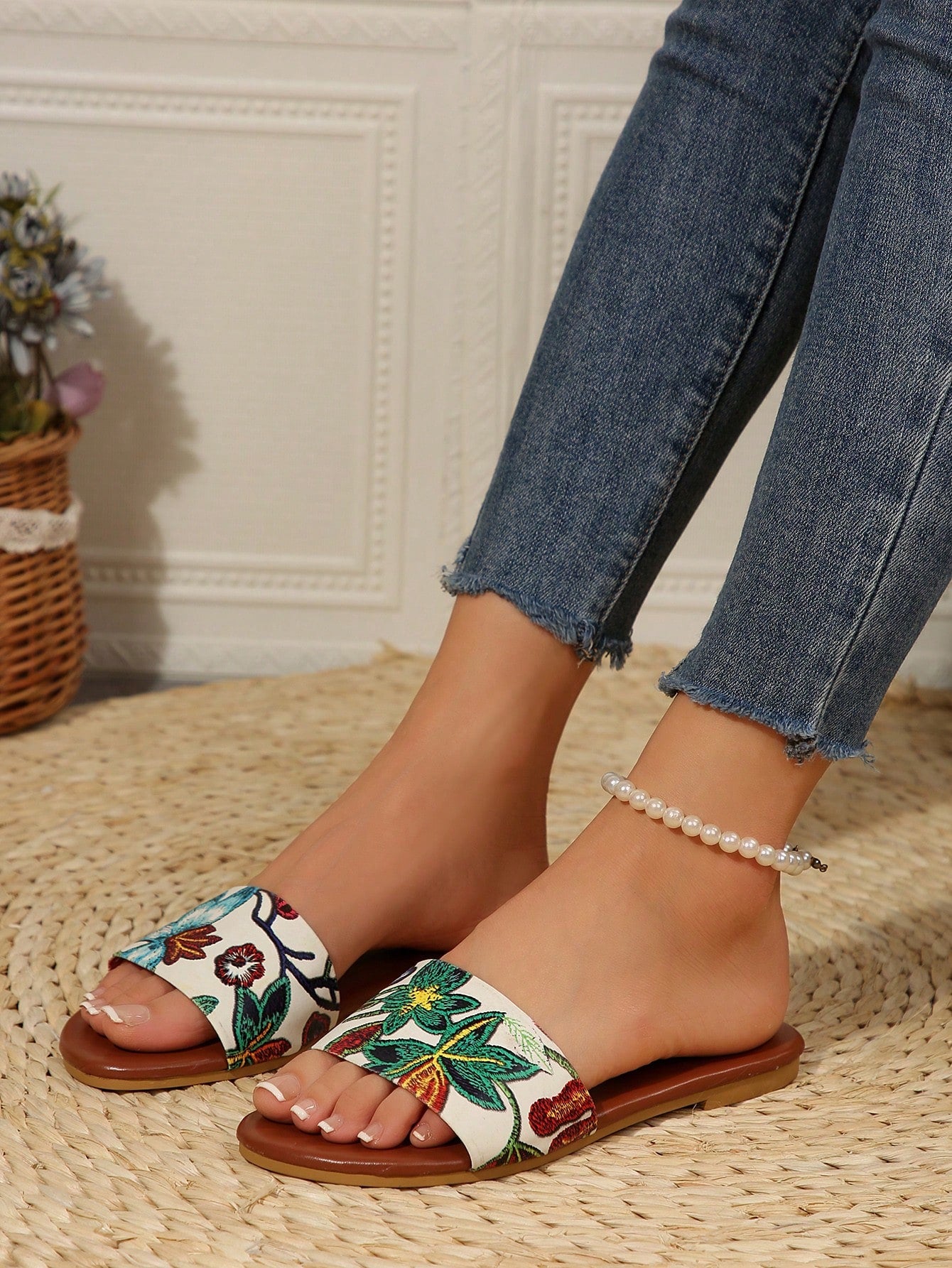 Pair of women's black flat slide sandals featuring rhinestone embellishments, metal accents, and a gold-strip detail on the upper, with an open-toe slip-on design.
