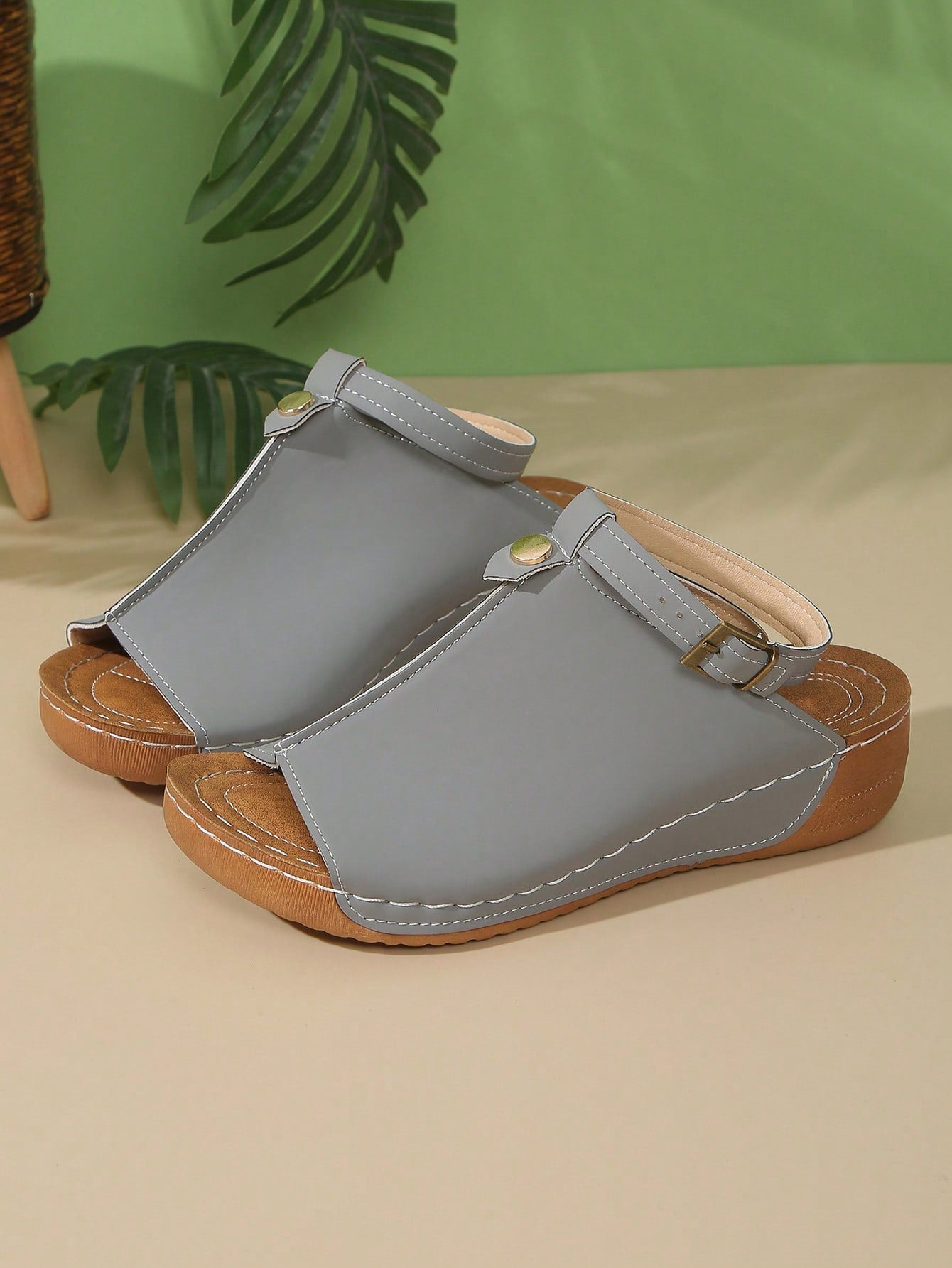 Women's open-toe platform wedge beach sandals with thick sole, stitching detail, floral accents, buckle closure, and removable adjustable shoelaces.