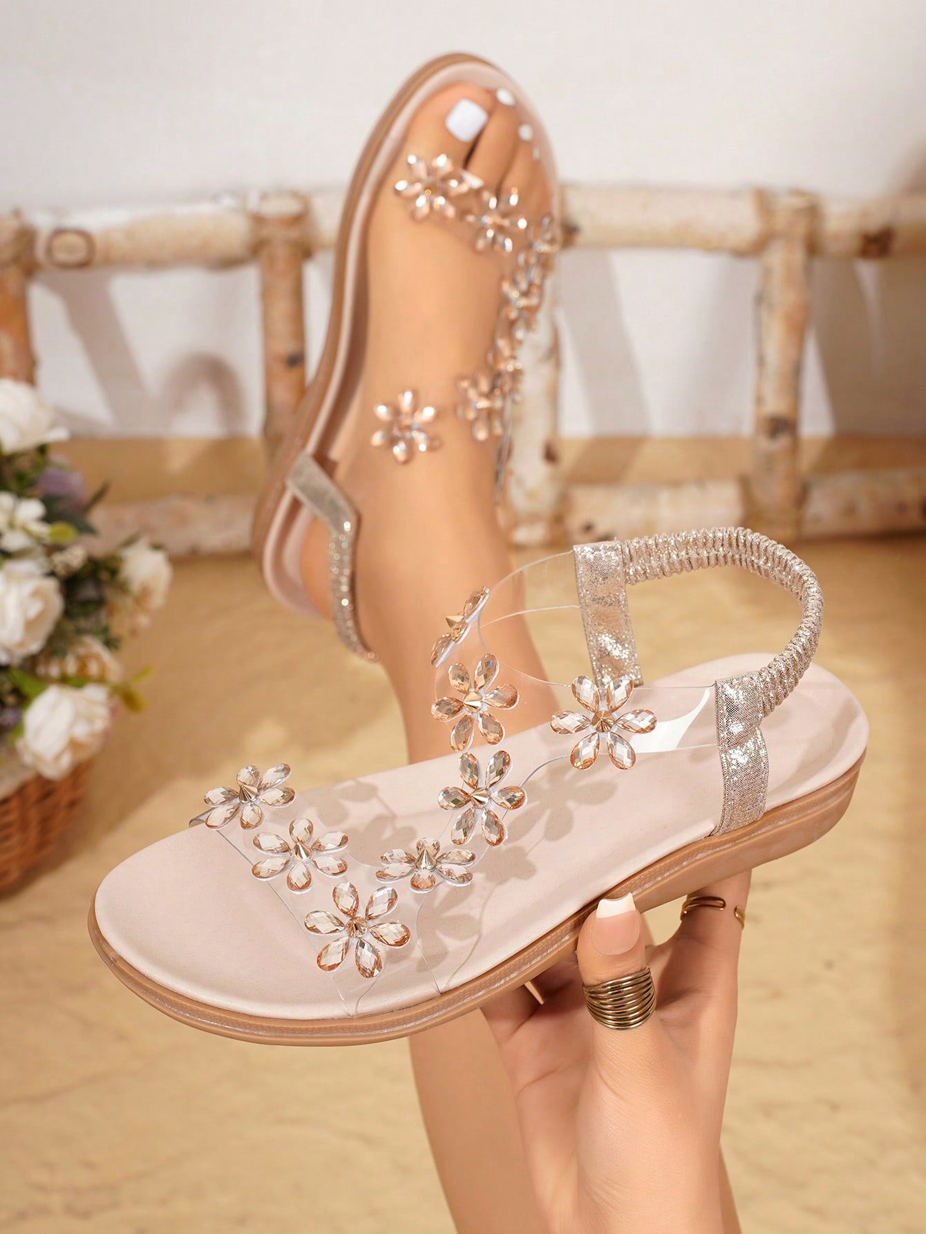 Women’s transparent flat sandals featuring crystal flower rhinestone decor, open toe design, and ankle strap on a flat anti-slip sole.