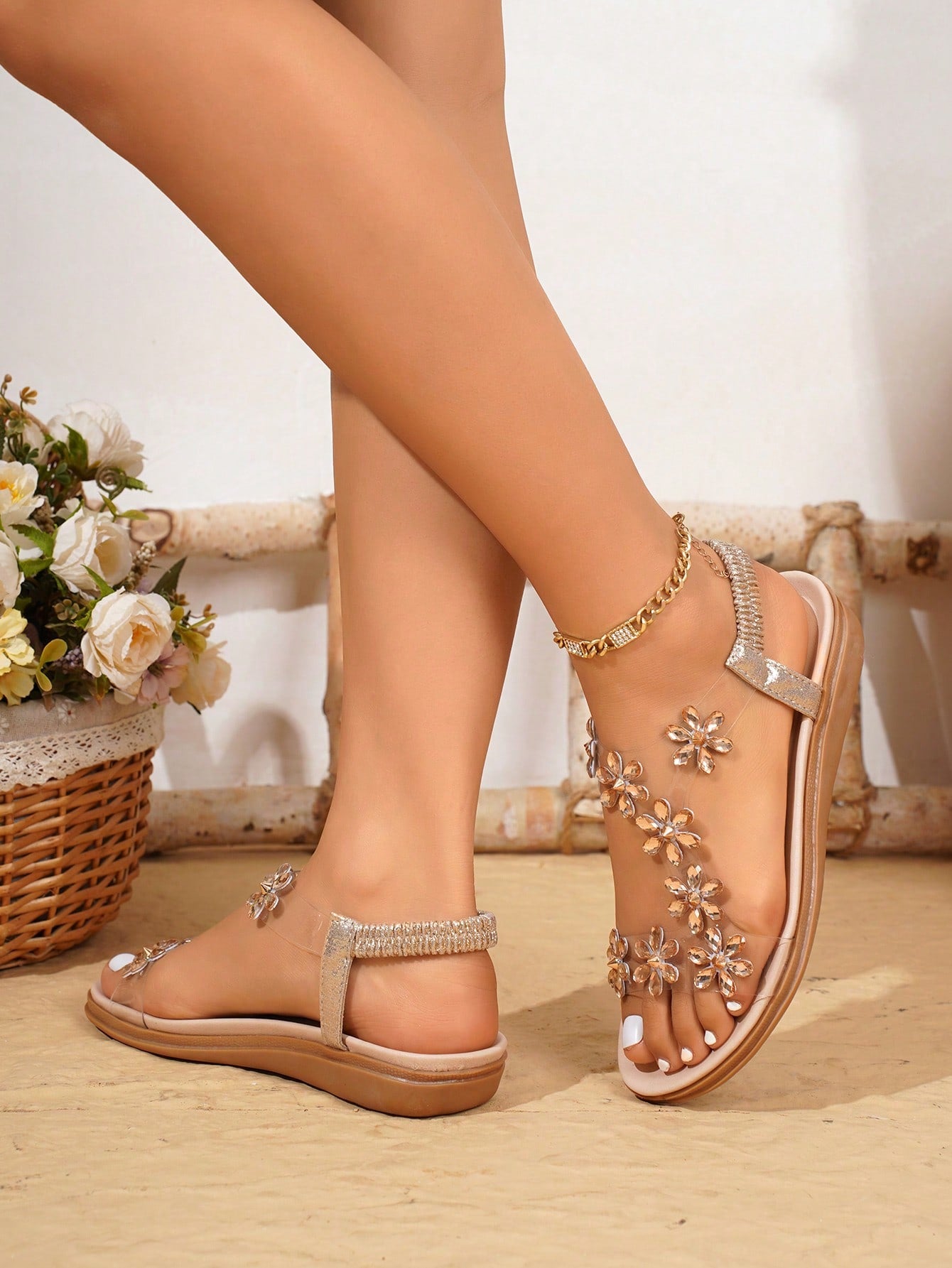 Women’s transparent flat sandals featuring crystal flower rhinestone decor, open toe design, and ankle strap on a flat anti-slip sole.