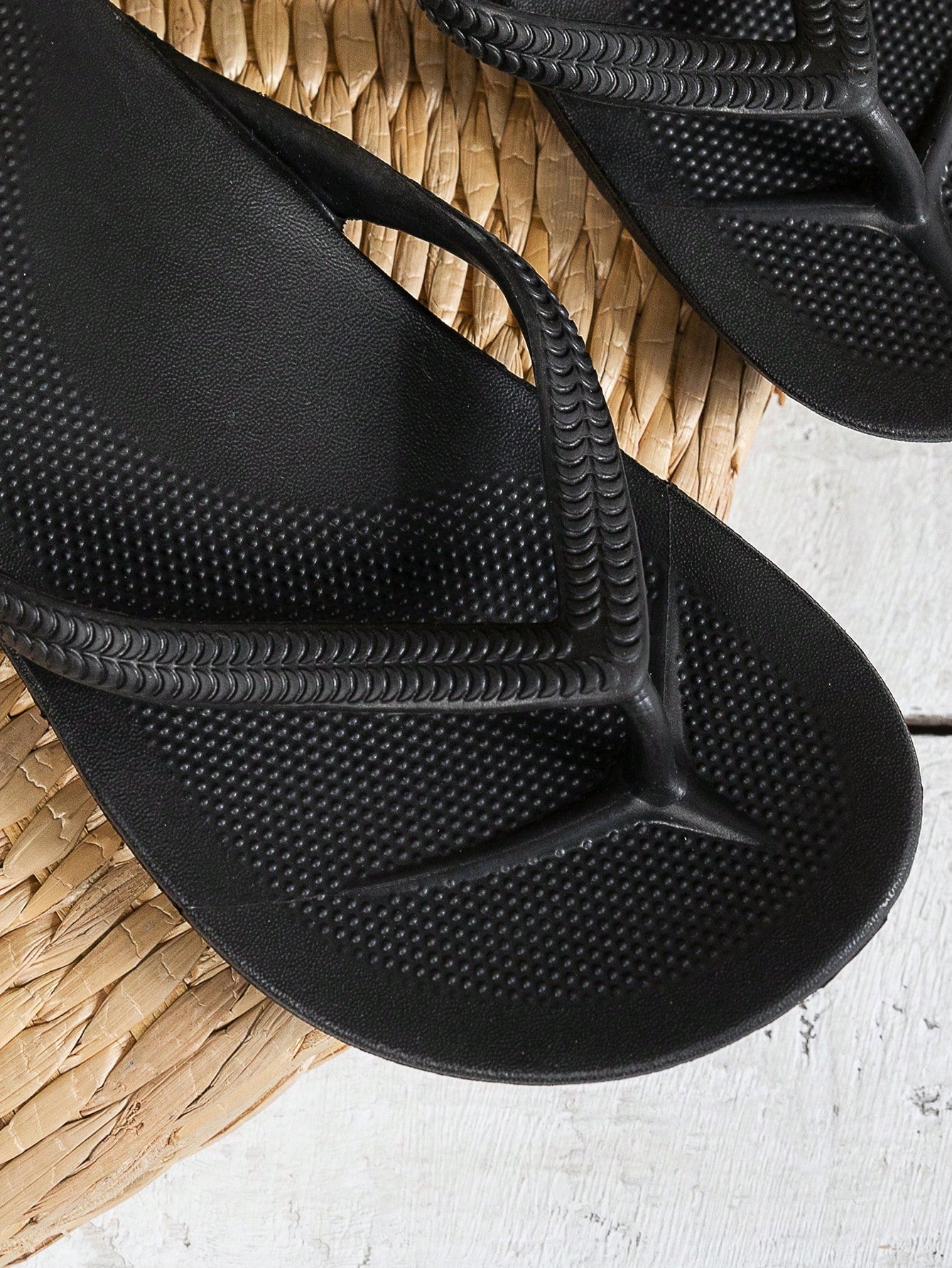 Women's solid color flip flops with open-toe design, flat sole, and cut-out details, suitable for casual indoor or outdoor wear at the beach or pool.