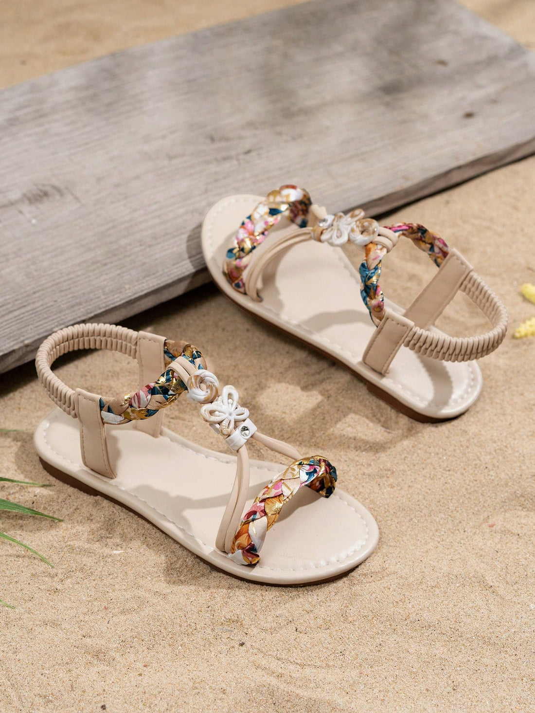 Beige kids slip-on slingback flat sandals with open toe, pearl and rhinestone embellishments, and plant pattern detail.