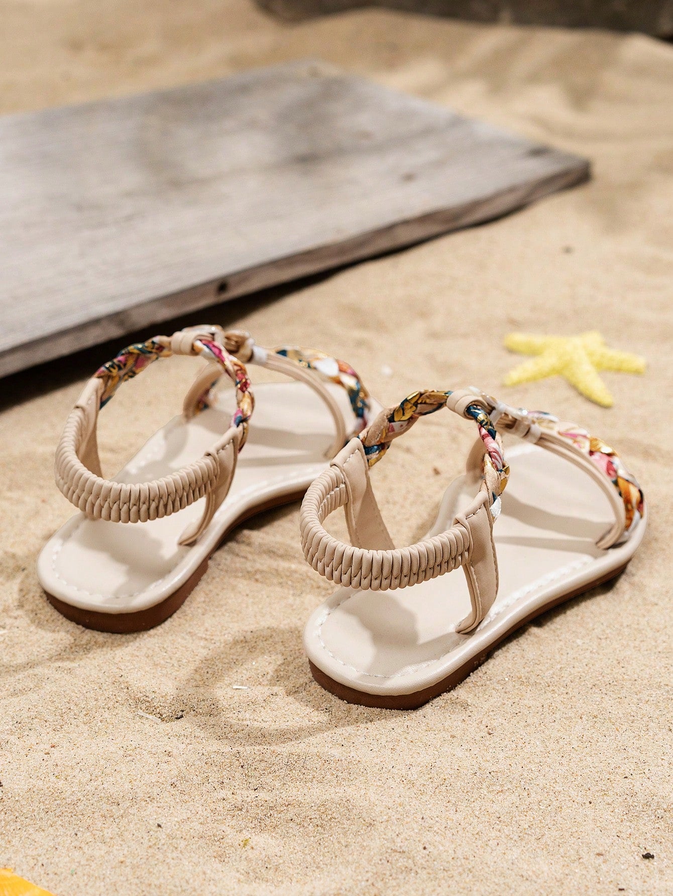 Beige kids slip-on slingback flat sandals with open toe, pearl and rhinestone embellishments, and plant pattern detail.