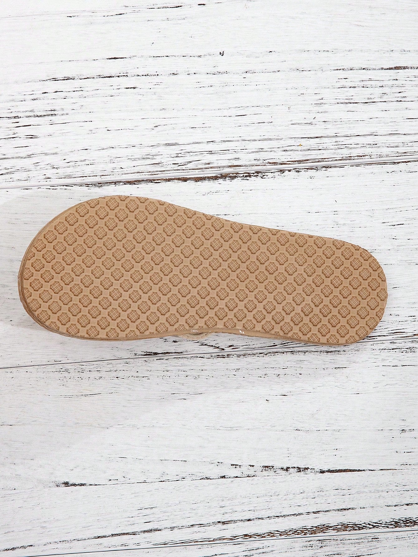 Women’s khaki flat flip-flop sandal with woven braided pattern and casual beach style.