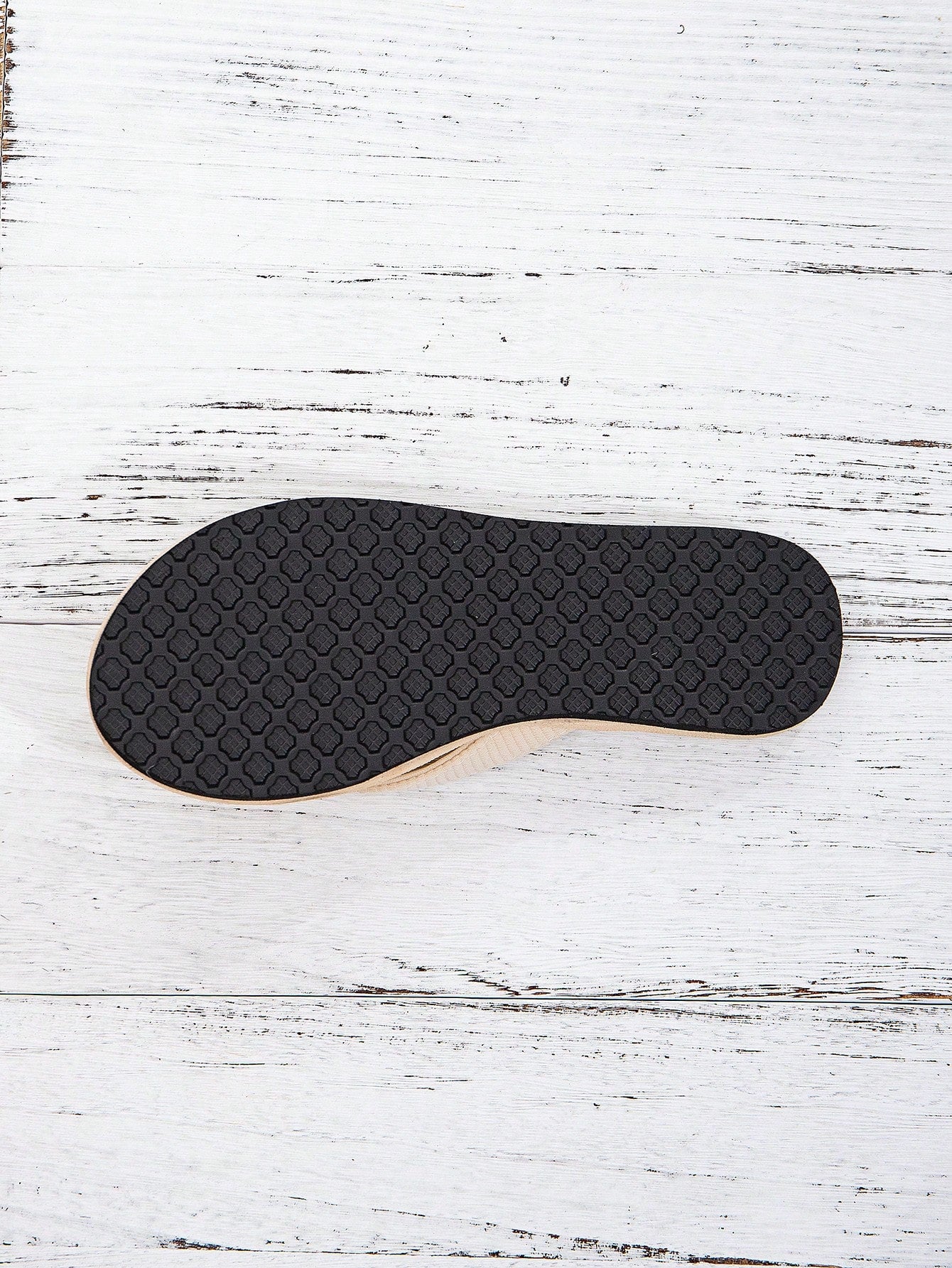 Women’s khaki flat flip-flop sandal with woven braided pattern and casual beach style.