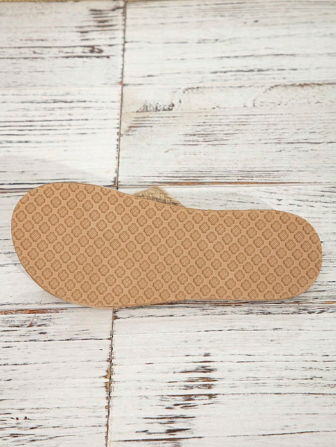 Women’s khaki flat flip-flop sandal with woven braided pattern and casual beach style.