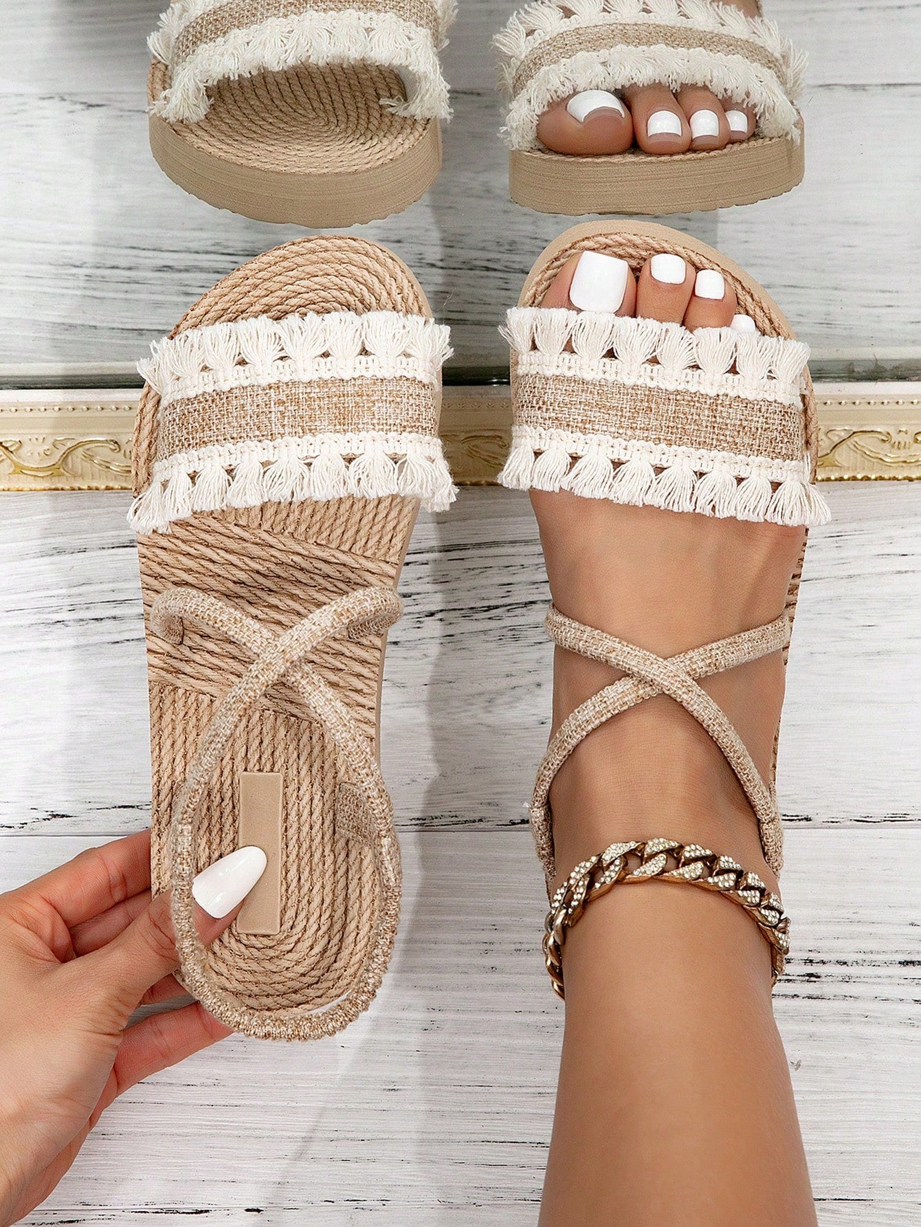 Women's white open-toe flat slide sandals featuring ruched fabric, bow accent, and fringe detail in a minimalist retro style.