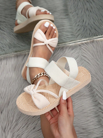 Women's beige flat slide sandals with ruched asymmetrical colorblock design and criss cross elastic fabric straps, casual slip-on style for outdoor wear.
