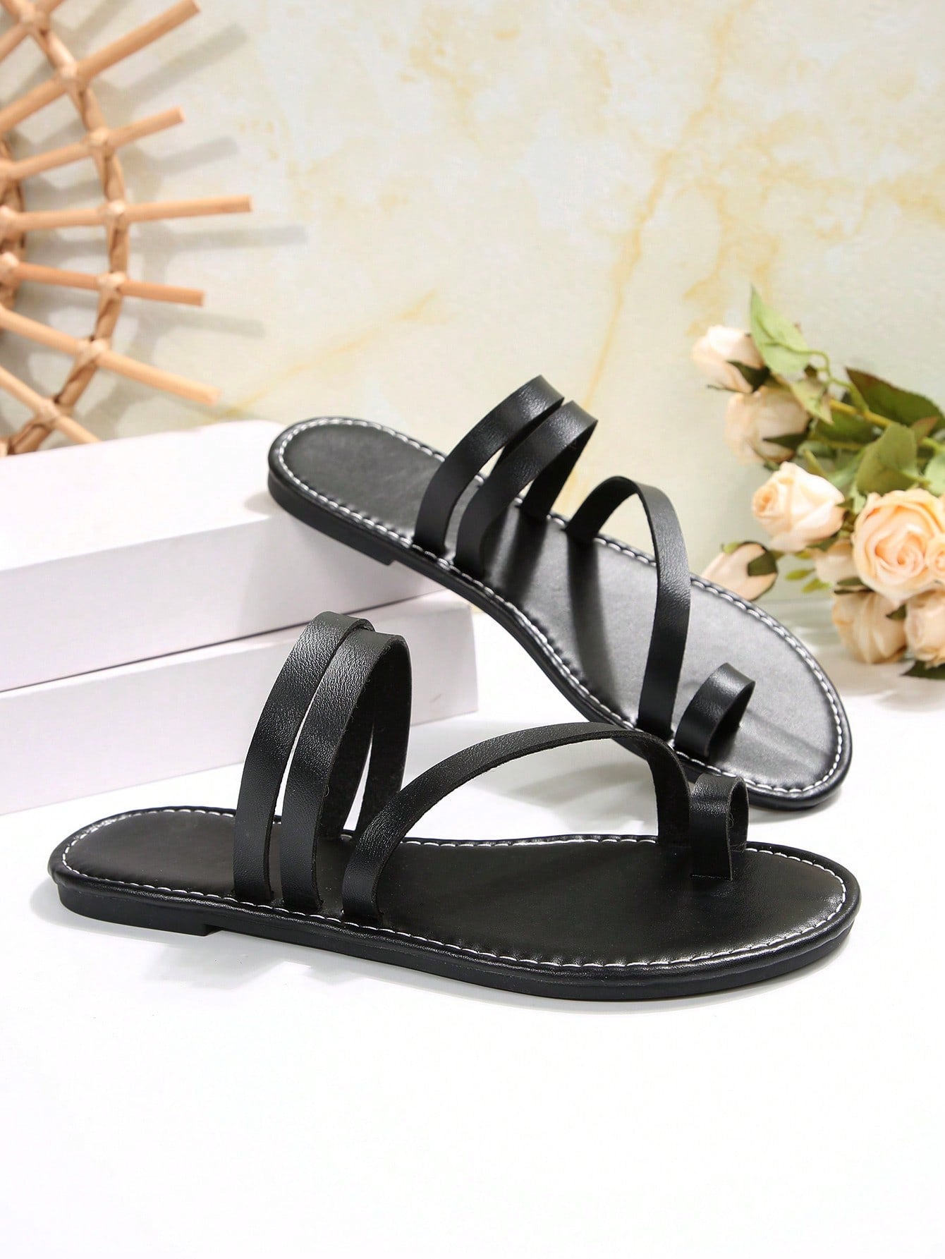 Women's flat slip-on sandal with toe ring and cross-over strappy upper, designed for casual beach and outdoor wear with an anti-slip sole.