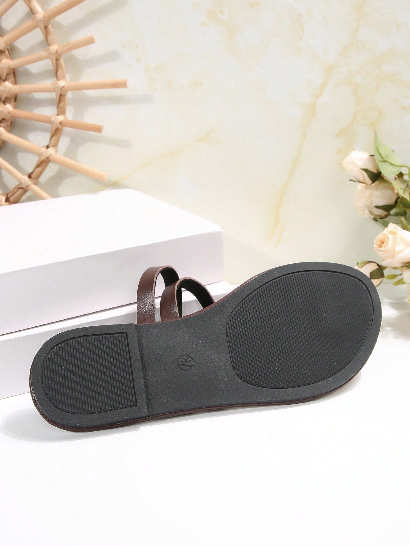 Women's flat slip-on sandal with toe ring and cross-over strappy upper, designed for casual beach and outdoor wear with an anti-slip sole.