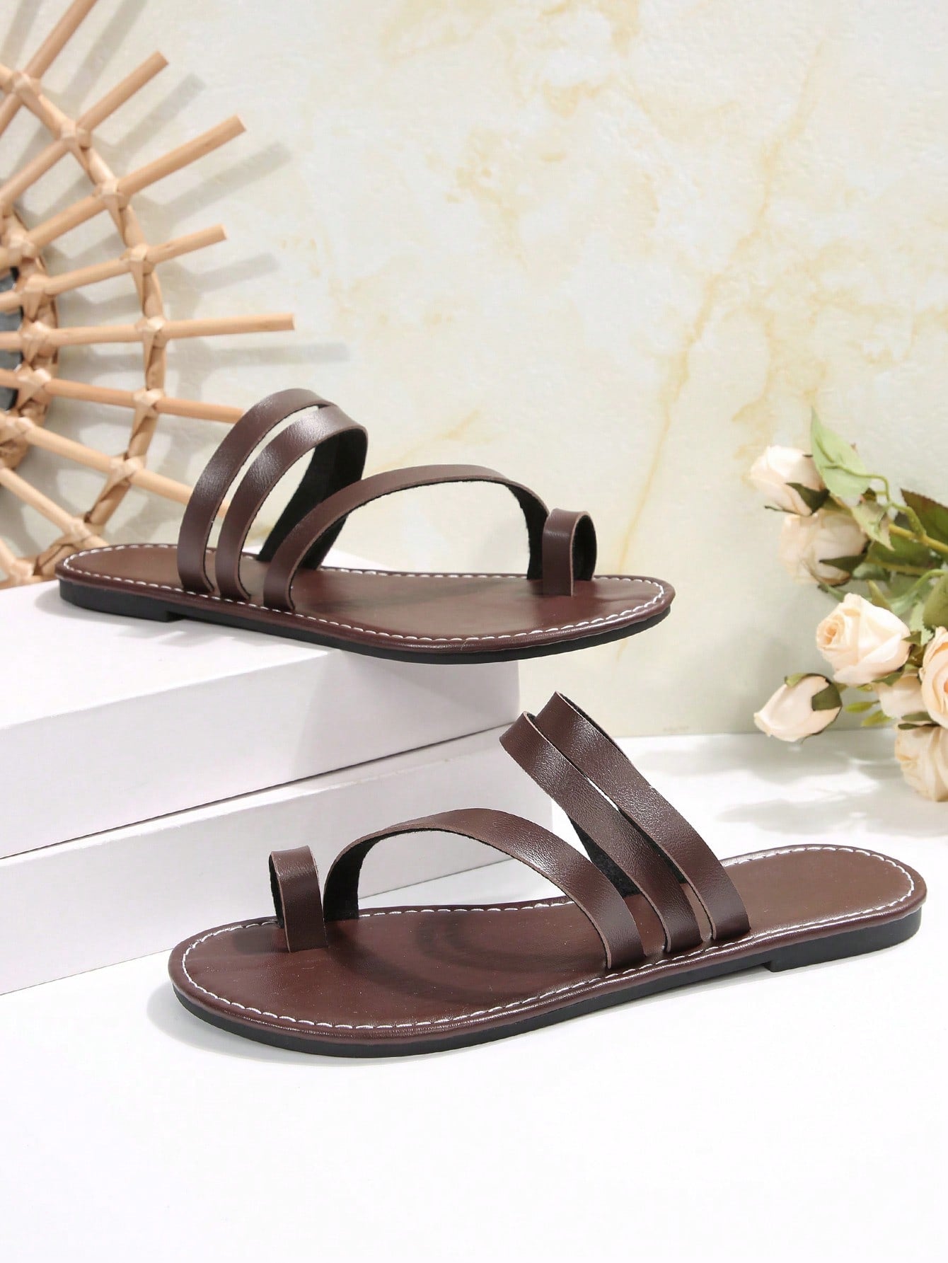 Women's flat slip-on sandal with toe ring and cross-over strappy upper, designed for casual beach and outdoor wear with an anti-slip sole.