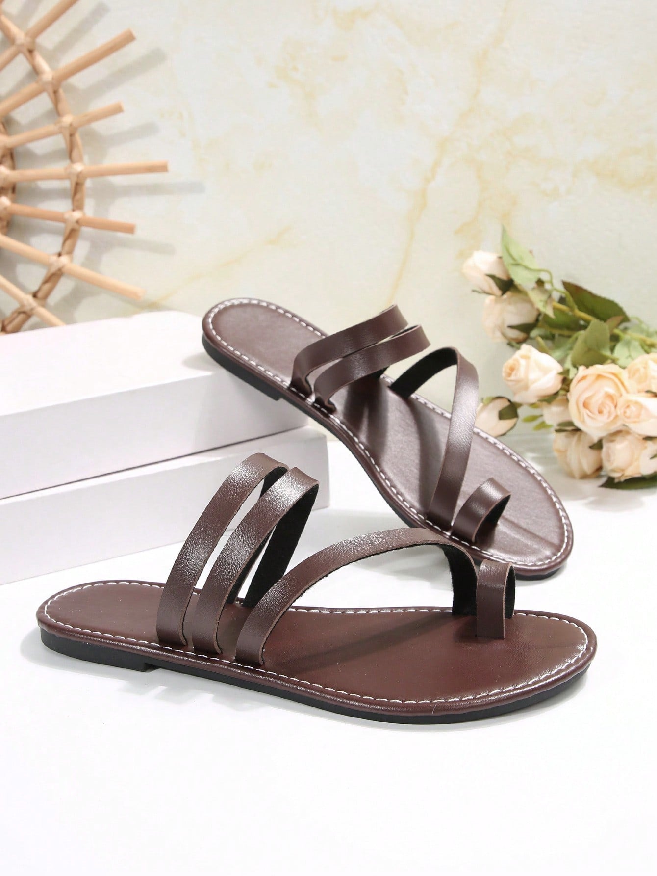 Women's flat slip-on sandal with toe ring and cross-over strappy upper, designed for casual beach and outdoor wear with an anti-slip sole.