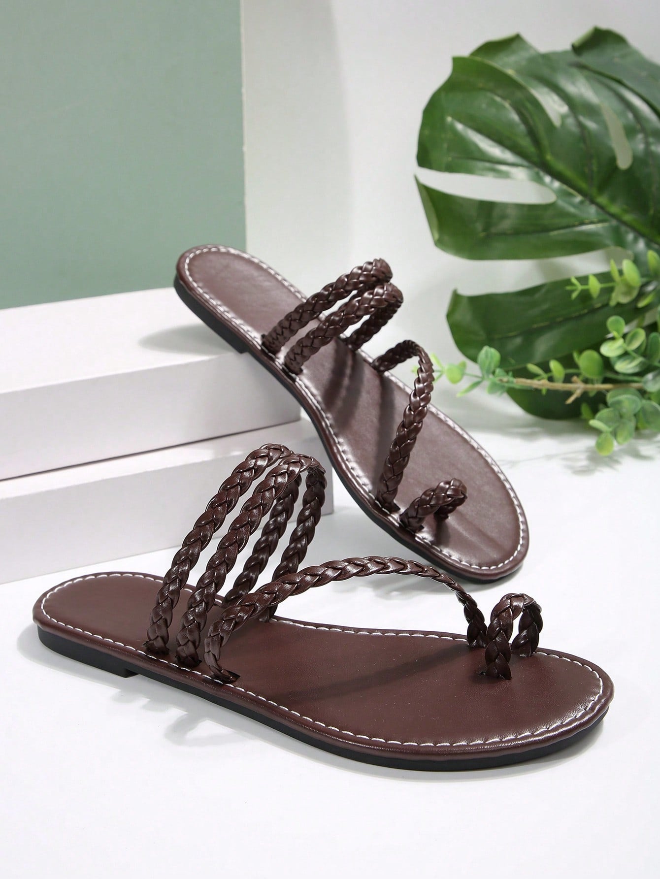 Women's flat slip-on sandal with toe ring and cross-over strappy upper, designed for casual beach and outdoor wear with an anti-slip sole.