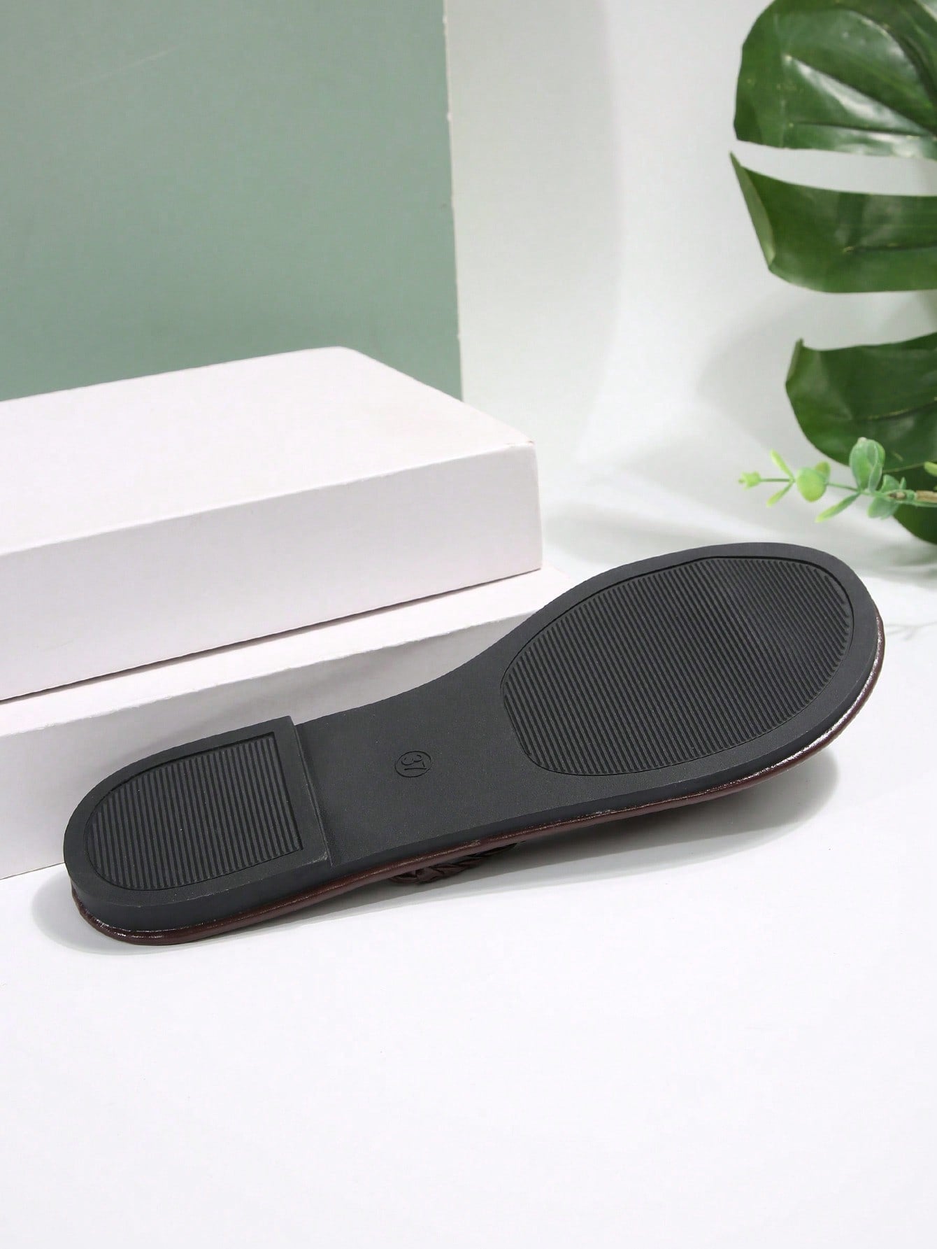 Women's chocolate brown flat flip flop sandals featuring a toe-post thong style and braided detail, suitable for casual indoor and outdoor wear.