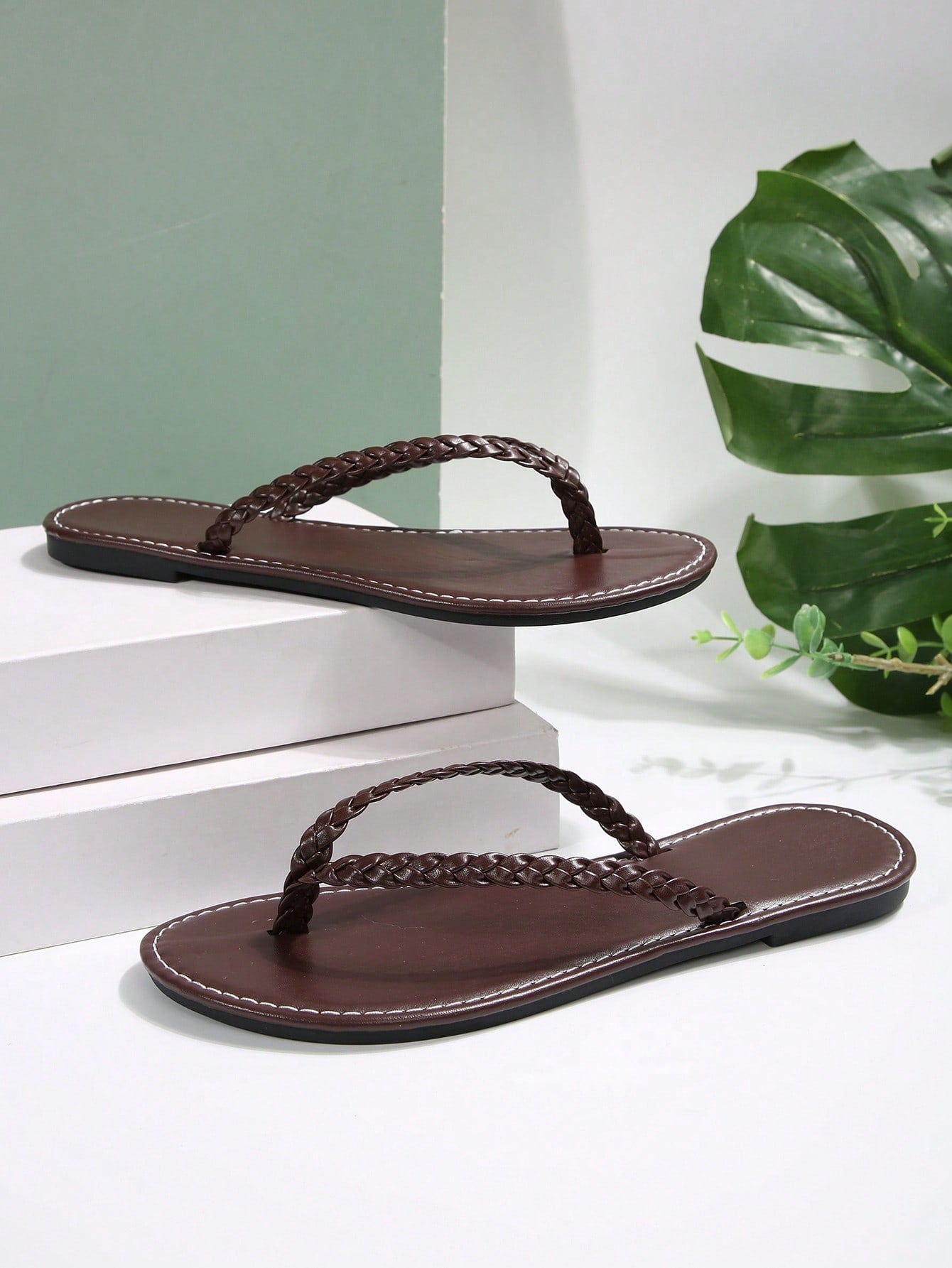 Women's chocolate brown flat flip flop sandals featuring a toe-post thong style and braided detail, suitable for casual indoor and outdoor wear.