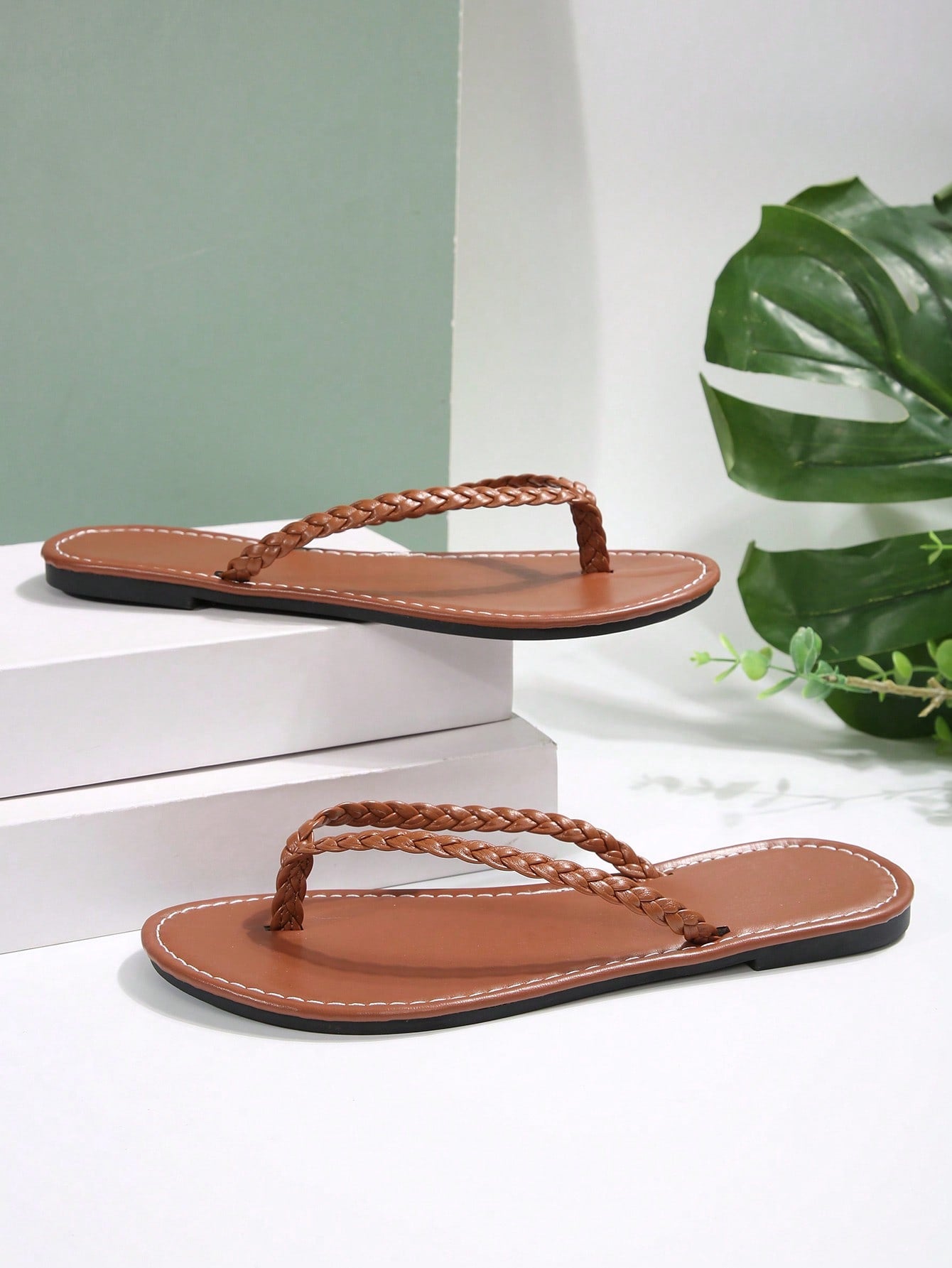 Women's chocolate brown flat flip flop sandals featuring a toe-post thong style and braided detail, suitable for casual indoor and outdoor wear.