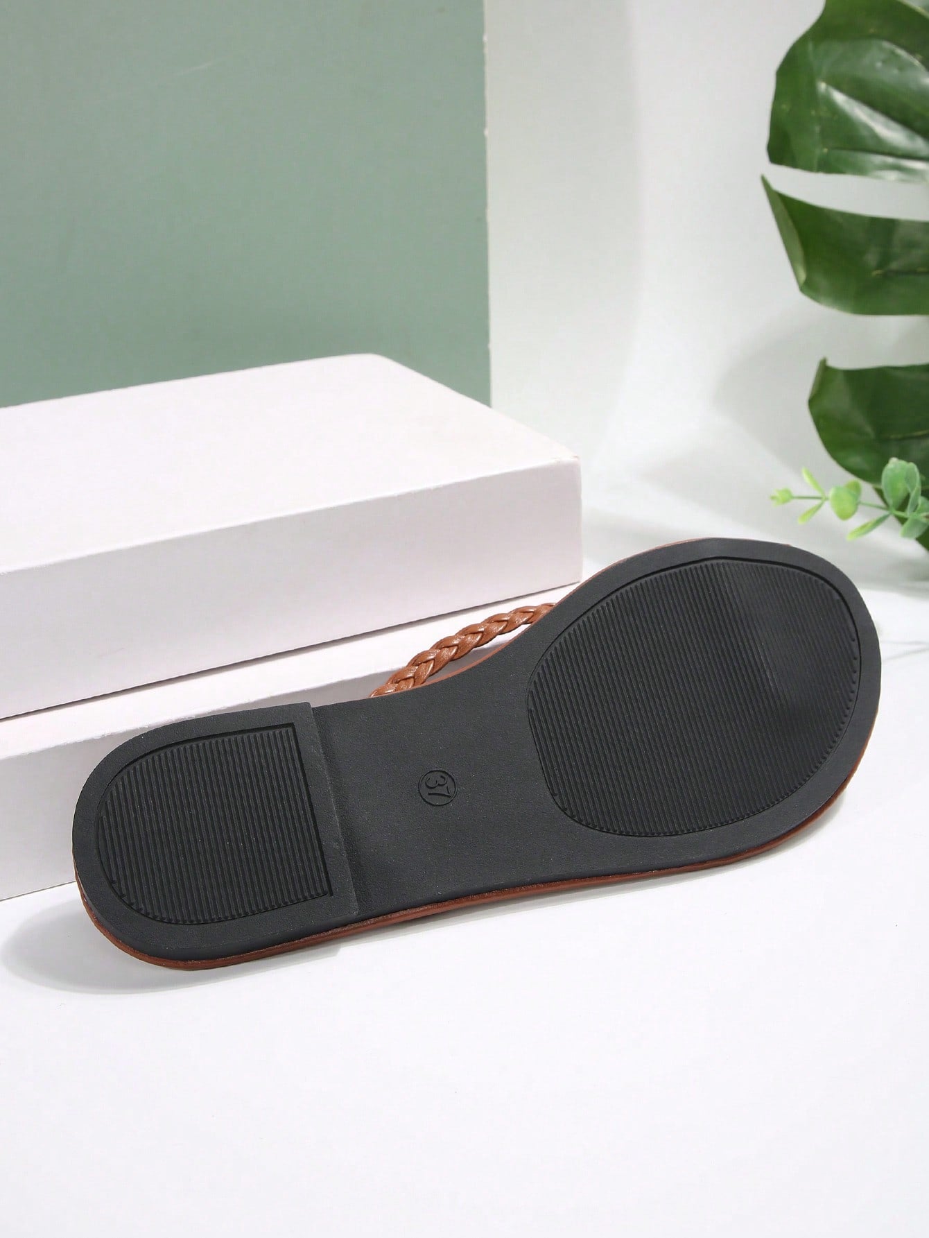 Women's chocolate brown flat flip flop sandals featuring a toe-post thong style and braided detail, suitable for casual indoor and outdoor wear.