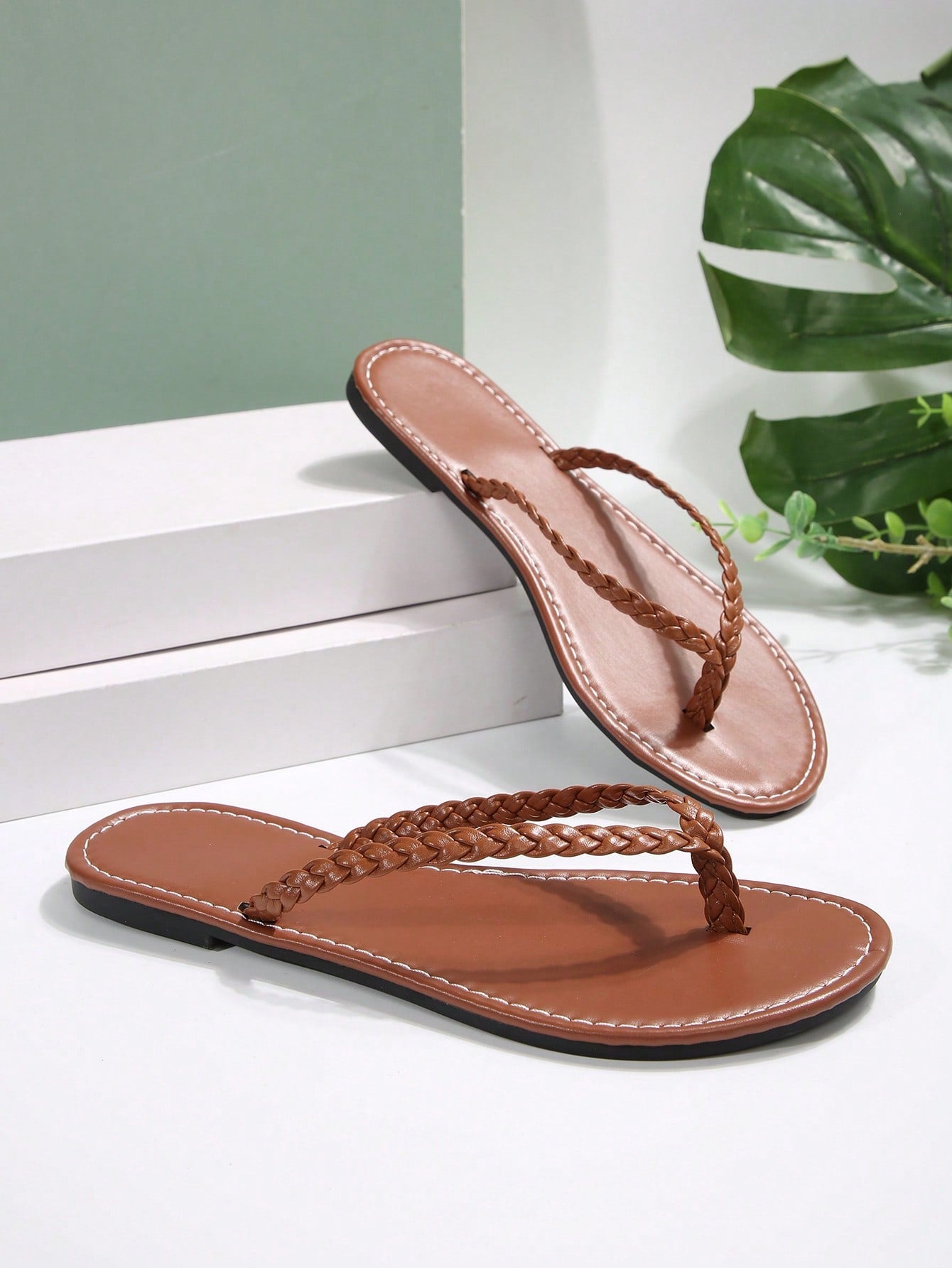 Women's chocolate brown flat flip flop sandals featuring a toe-post thong style and braided detail, suitable for casual indoor and outdoor wear.