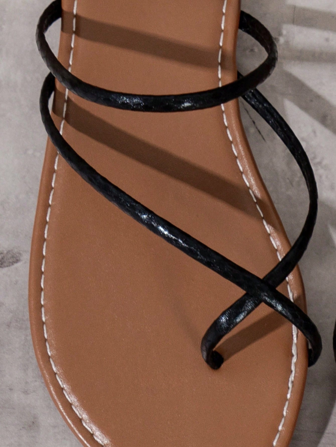 Women’s gold thong flat sandals with strappy asymmetrical design, suitable for outdoor and beach wear