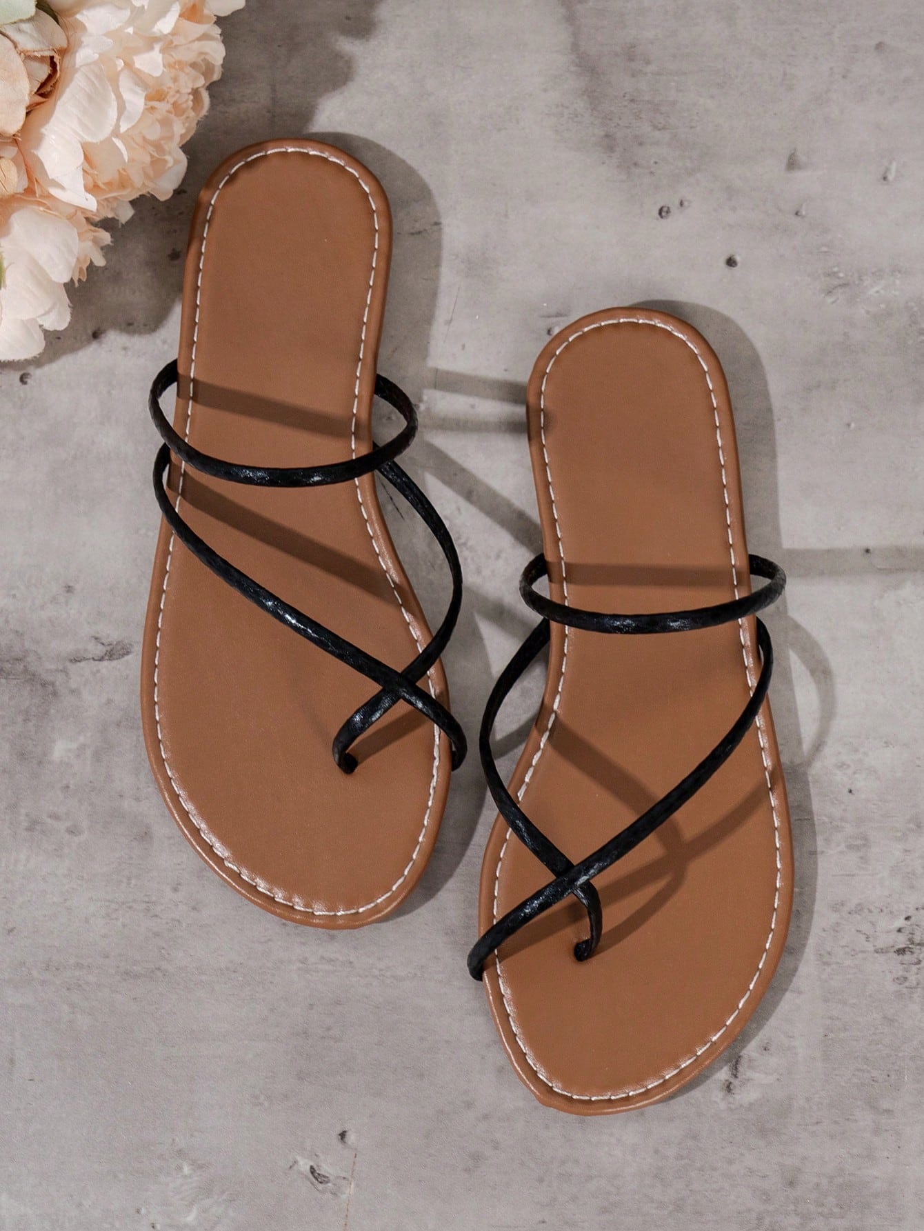 Women’s gold thong flat sandals with strappy asymmetrical design, suitable for outdoor and beach wear