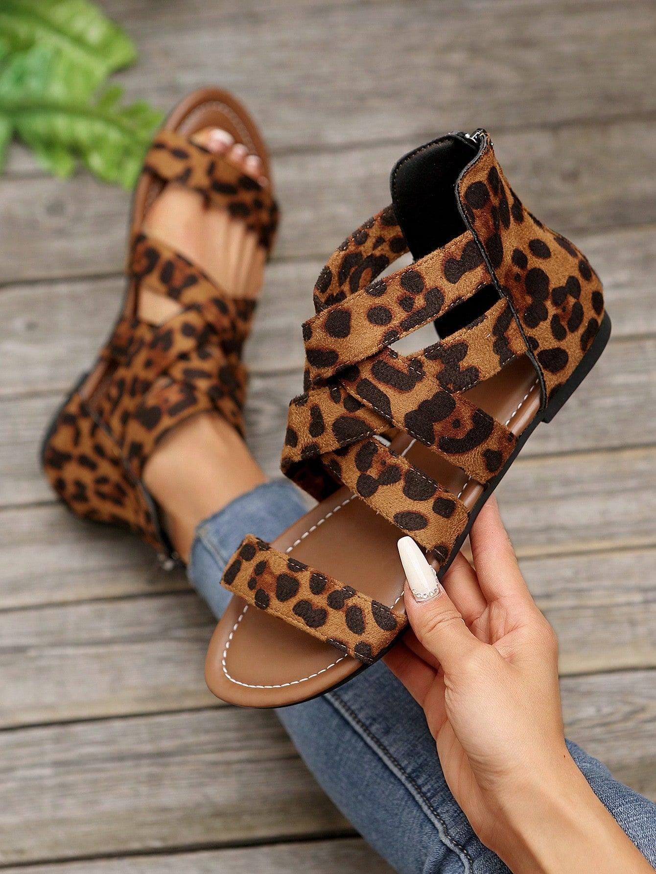 Pair of women’s floral beaded Roman style flat gladiator sandals with open toe design, suitable for beach and vacation wear.