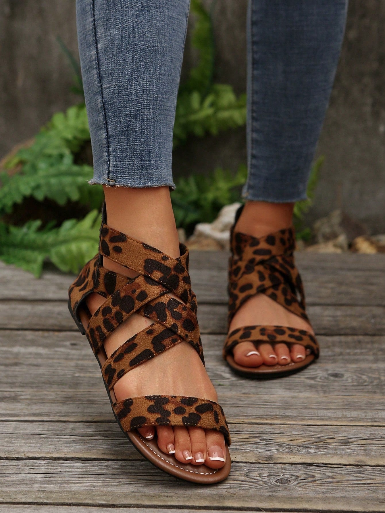 Pair of women’s floral beaded Roman style flat gladiator sandals with open toe design, suitable for beach and vacation wear.