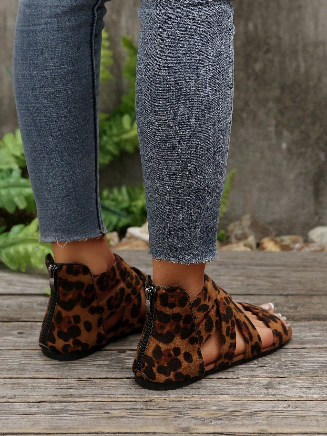 Pair of women’s floral beaded Roman style flat gladiator sandals with open toe design, suitable for beach and vacation wear.