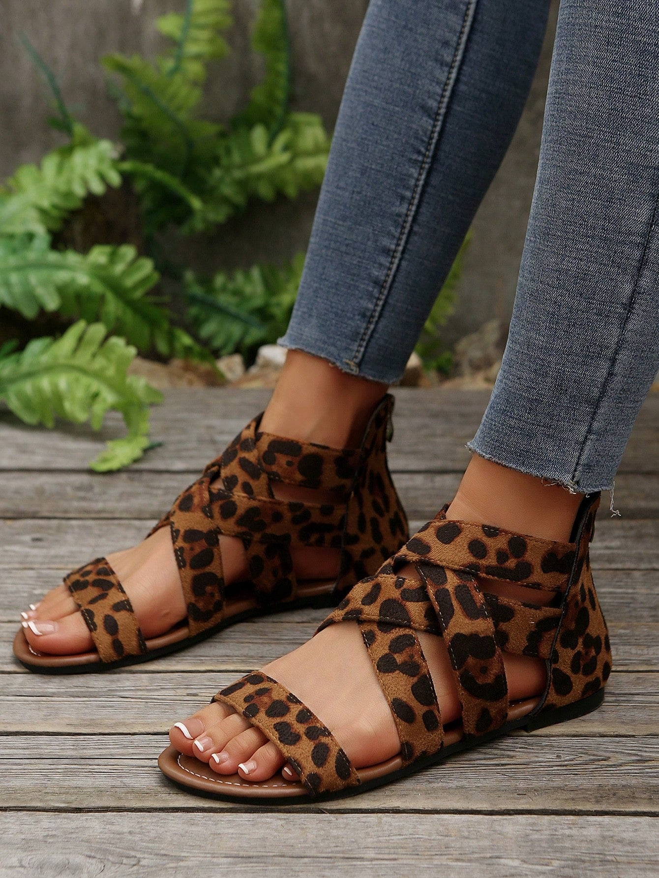 Pair of women’s floral beaded Roman style flat gladiator sandals with open toe design, suitable for beach and vacation wear.