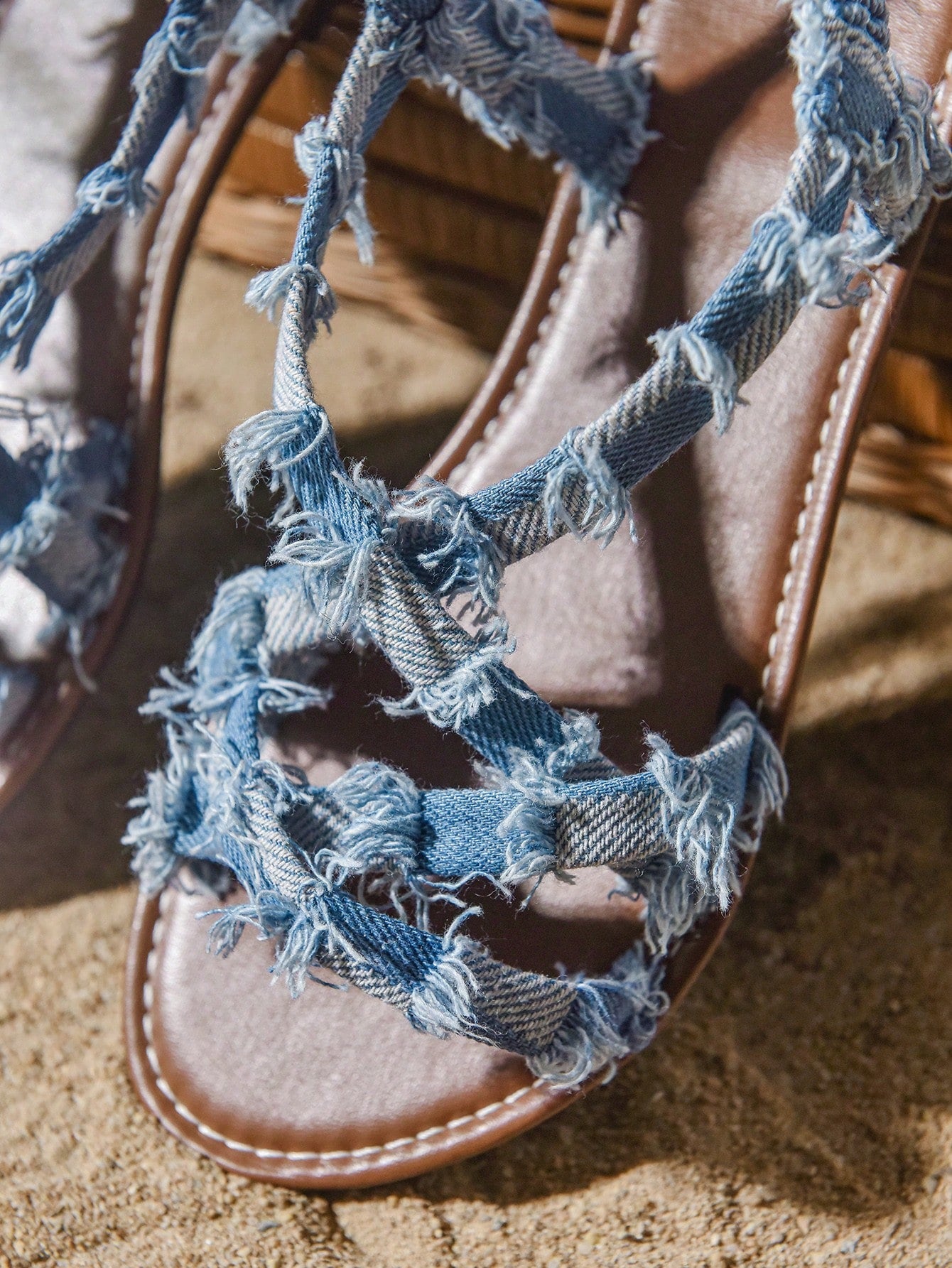 Plus size women's blue slip-on flat gladiator sandals with criss cross straps and open toe, shown in a casual beach style for spring and summer outfits.