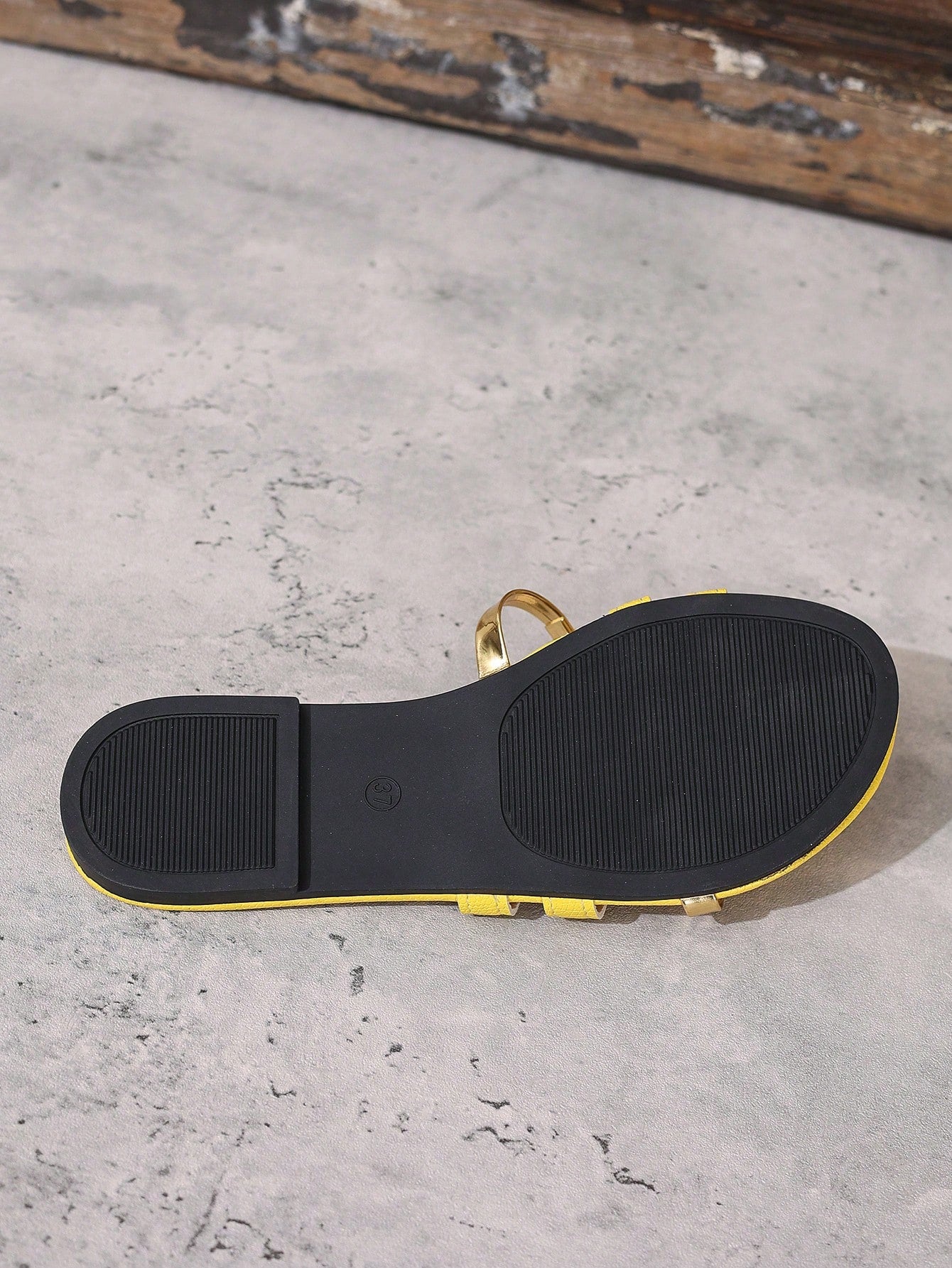 Women's yellow open-toe flat slide sandals featuring a cut-out design and textured plain pattern for casual beach and daily wear.